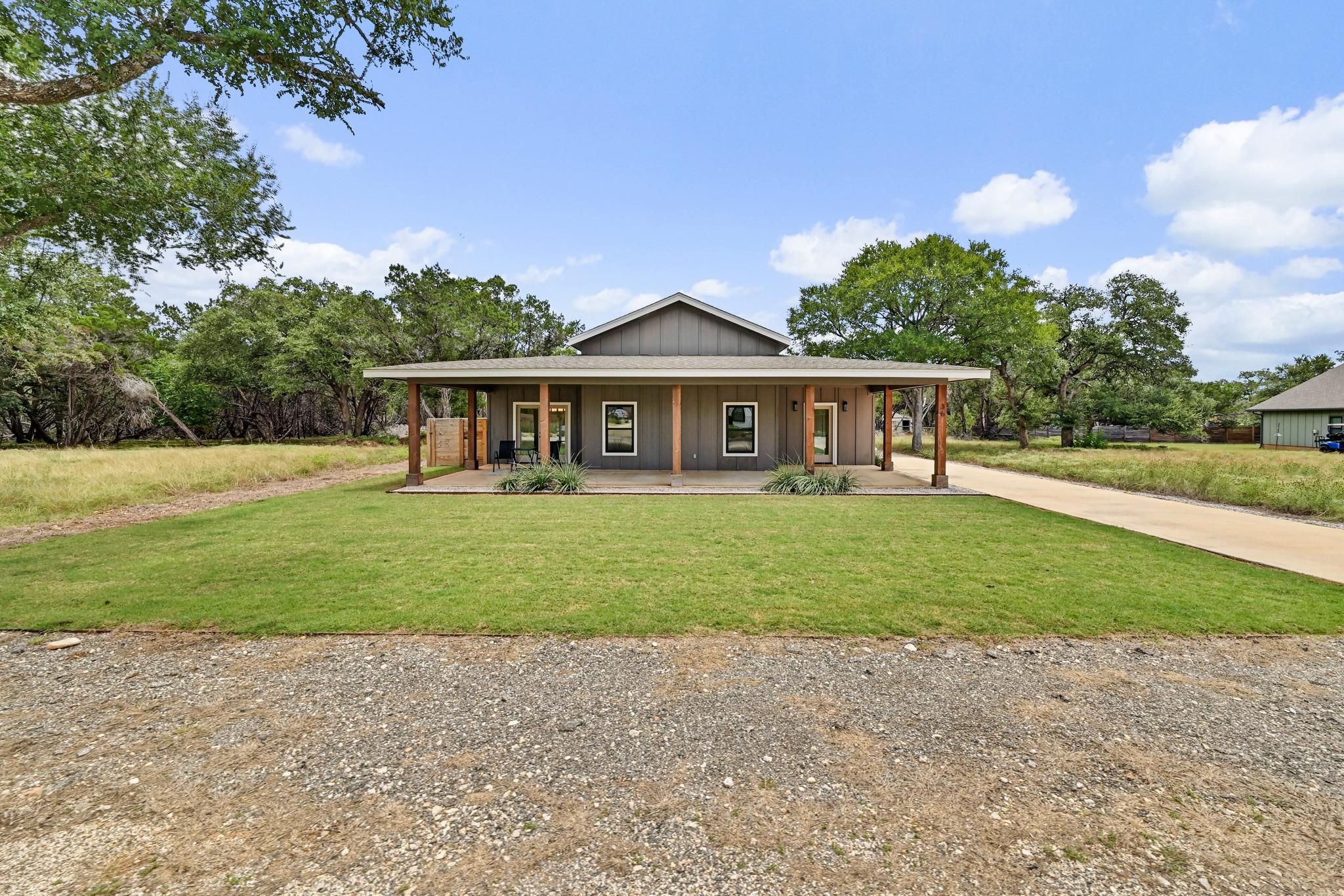 A welcoming front porch extends across this charm