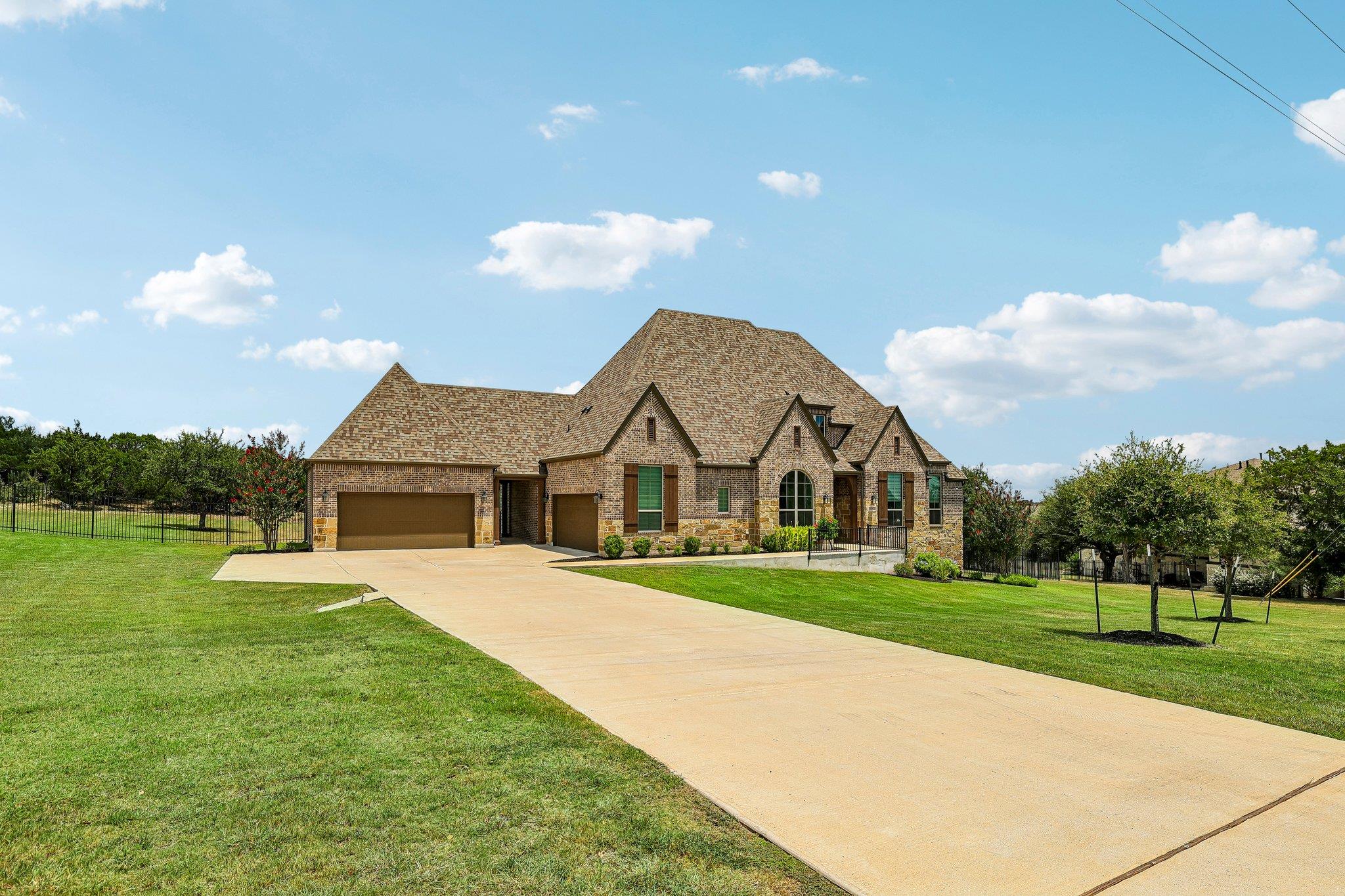 A grand brick and stone residence, featuring mult