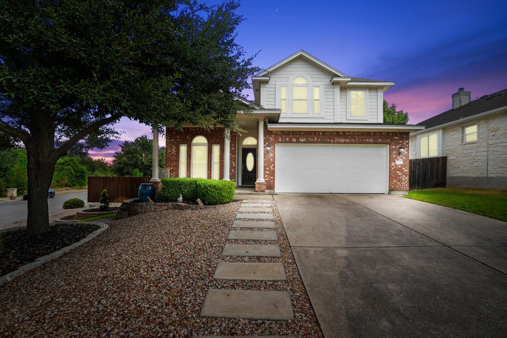 A classic brick and siding exterior meets manicur