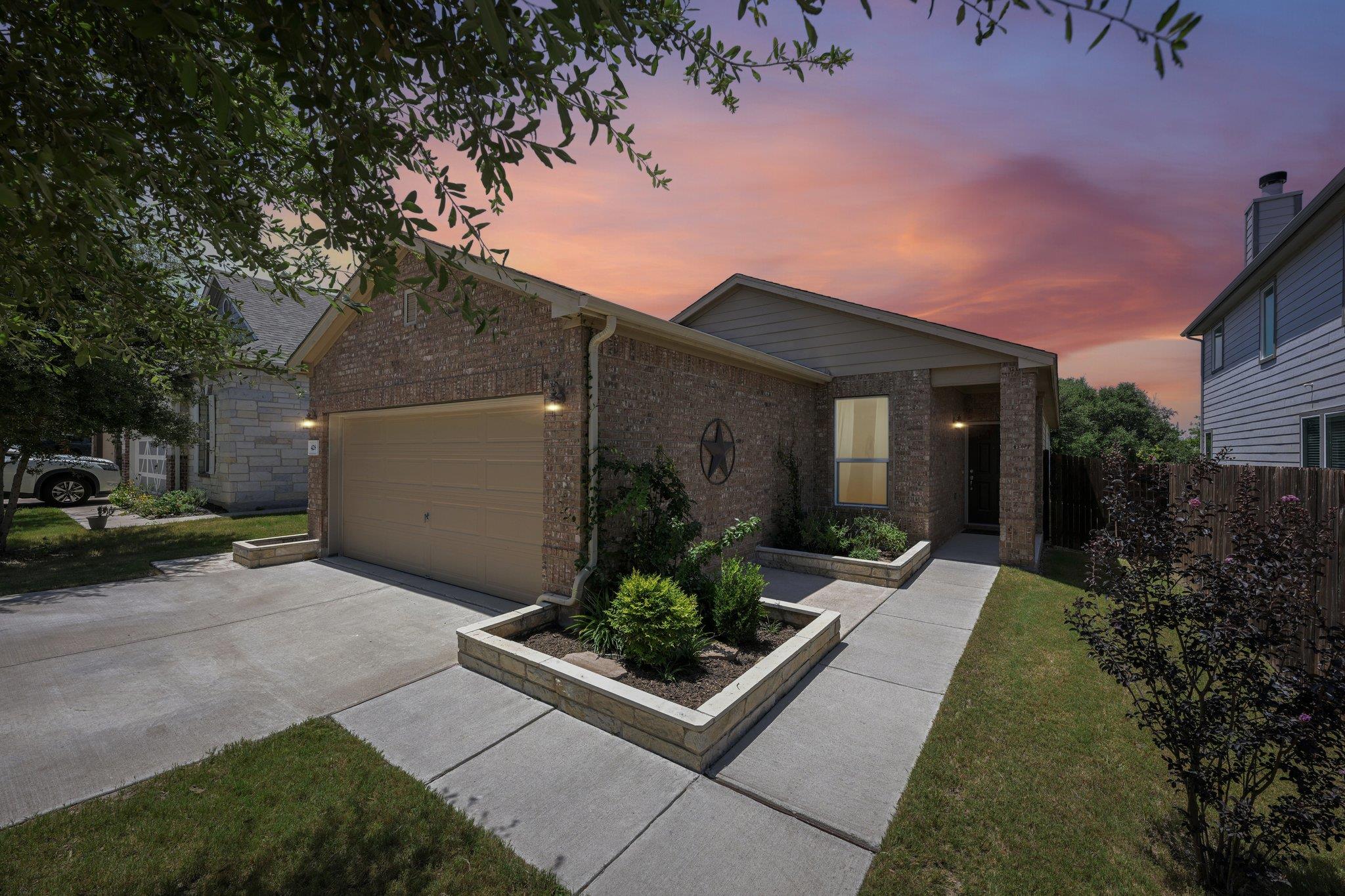 Brick facade and manicured planter boxes adorn th