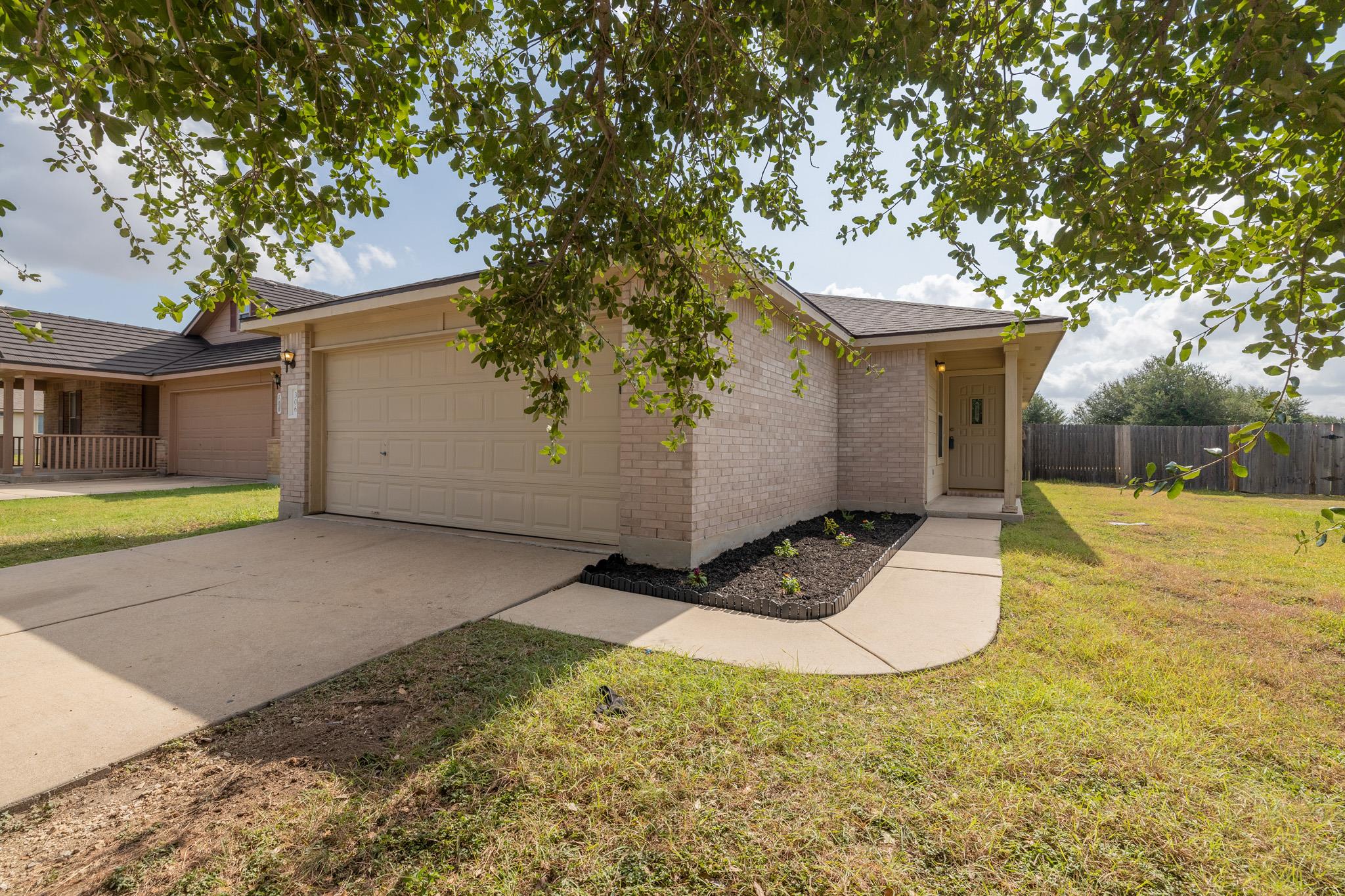 A well-maintained lawn welcomes you to this invit