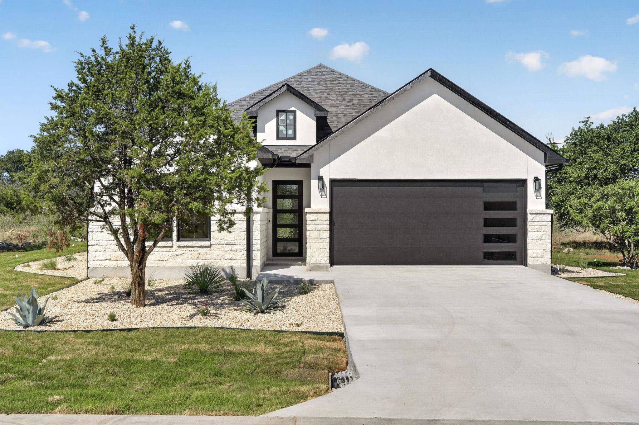 Crisp stucco and stone accents frame this modern 