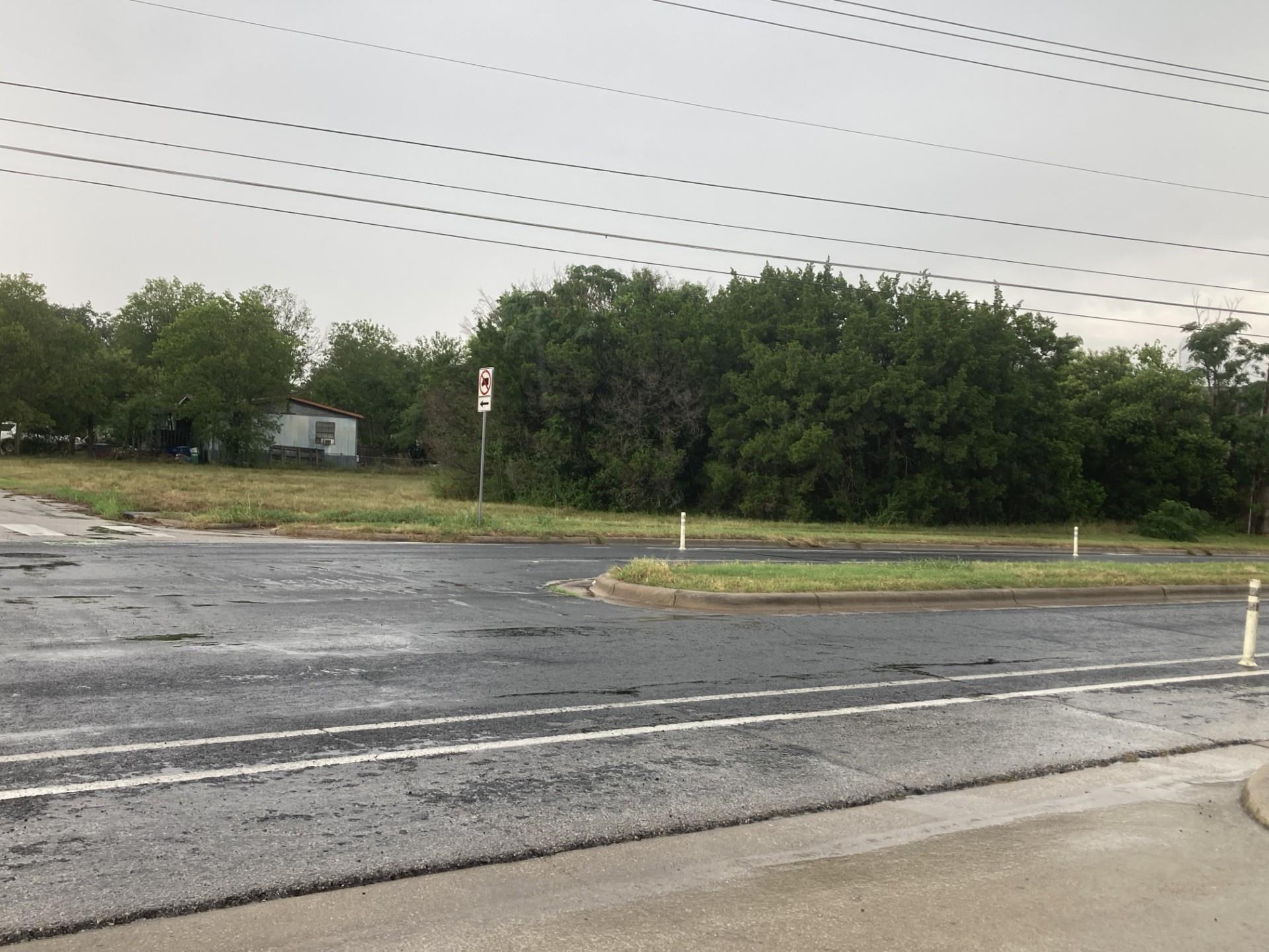 A well-located vacant lot awaits development at a