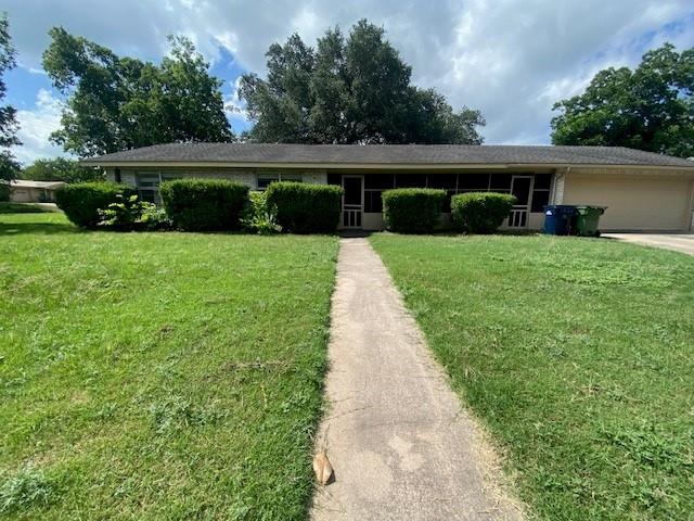 A well-maintained lawn and established shrubs enh