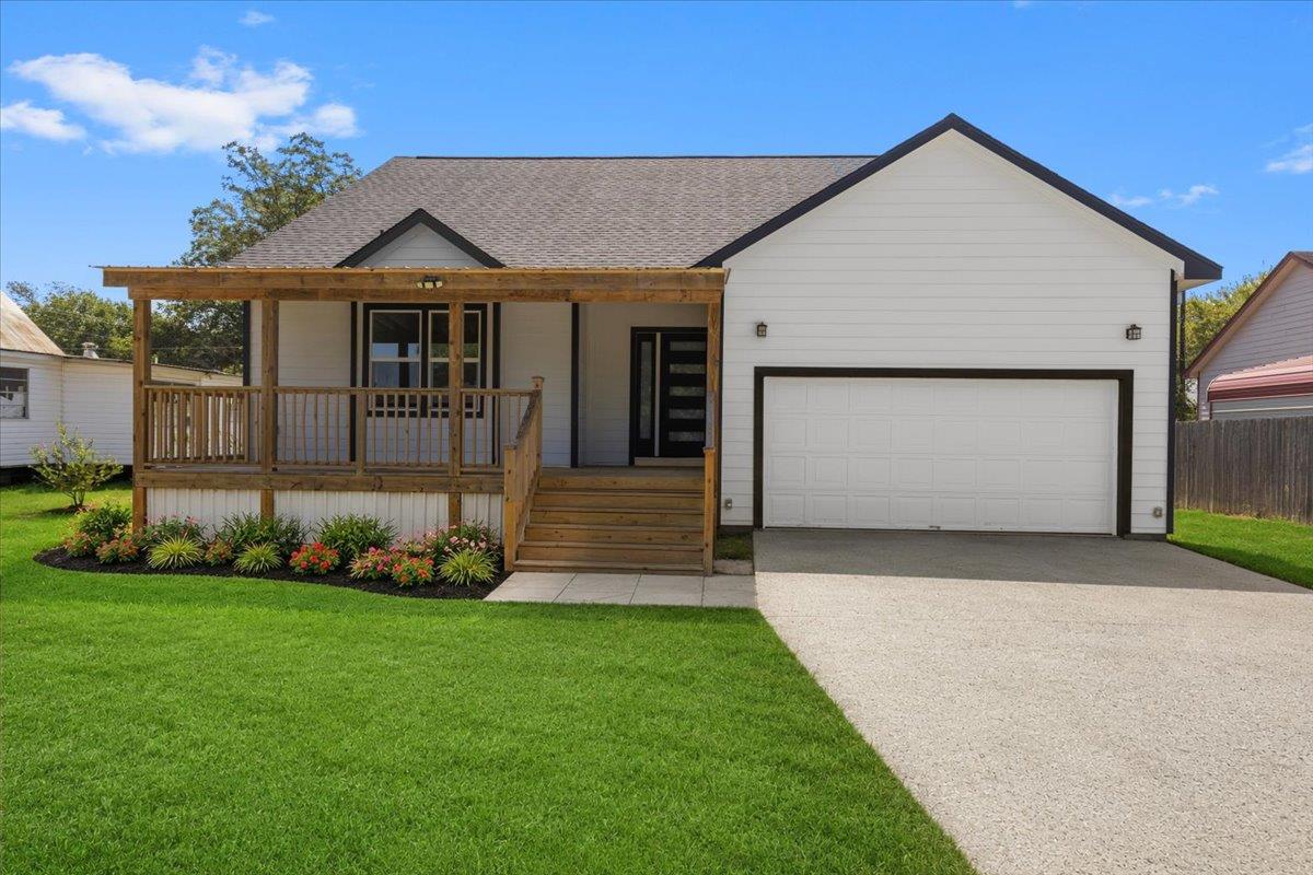 A spacious covered front porch complements the ti