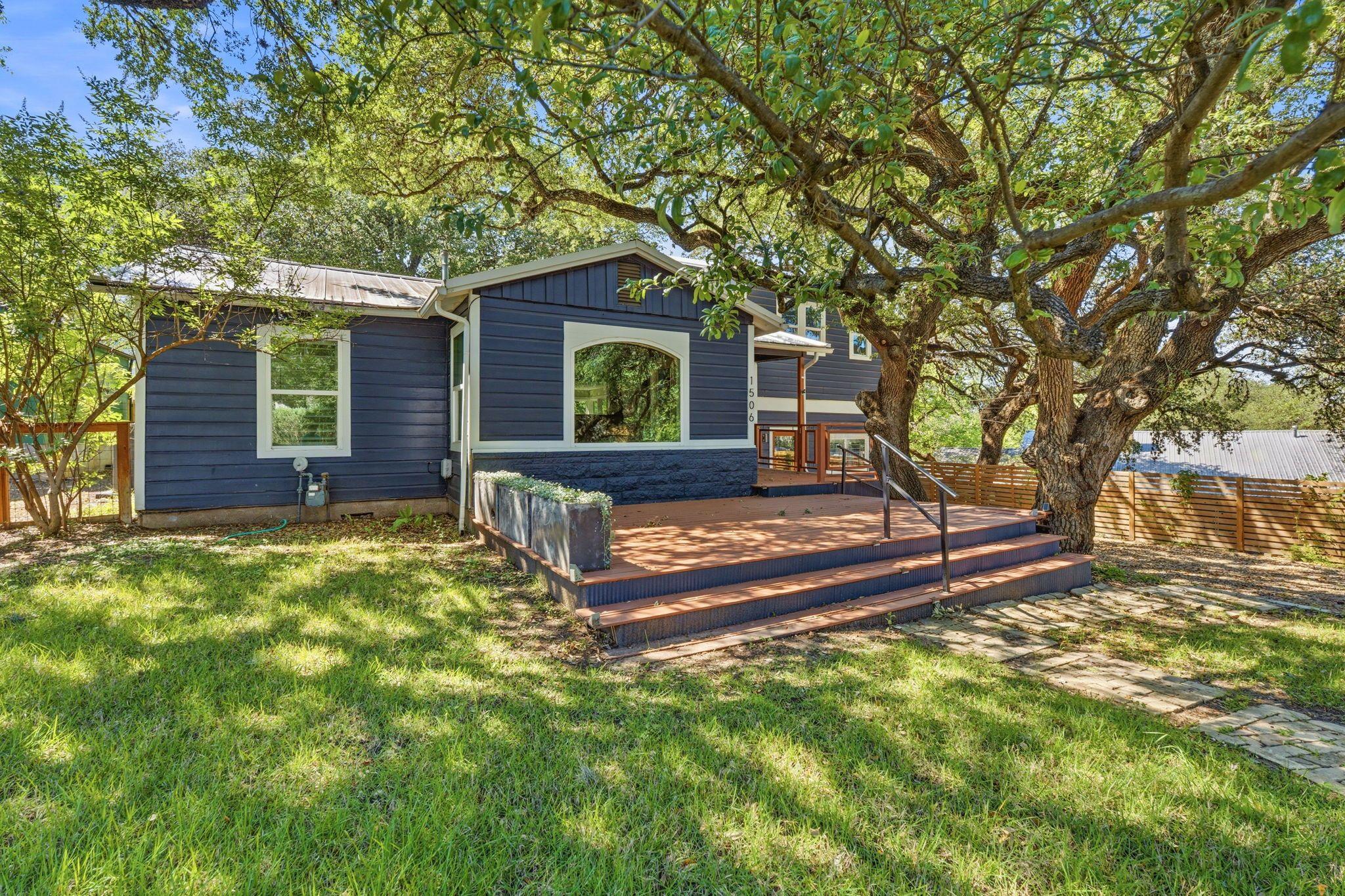 A charming home boasts a spacious front deck, per