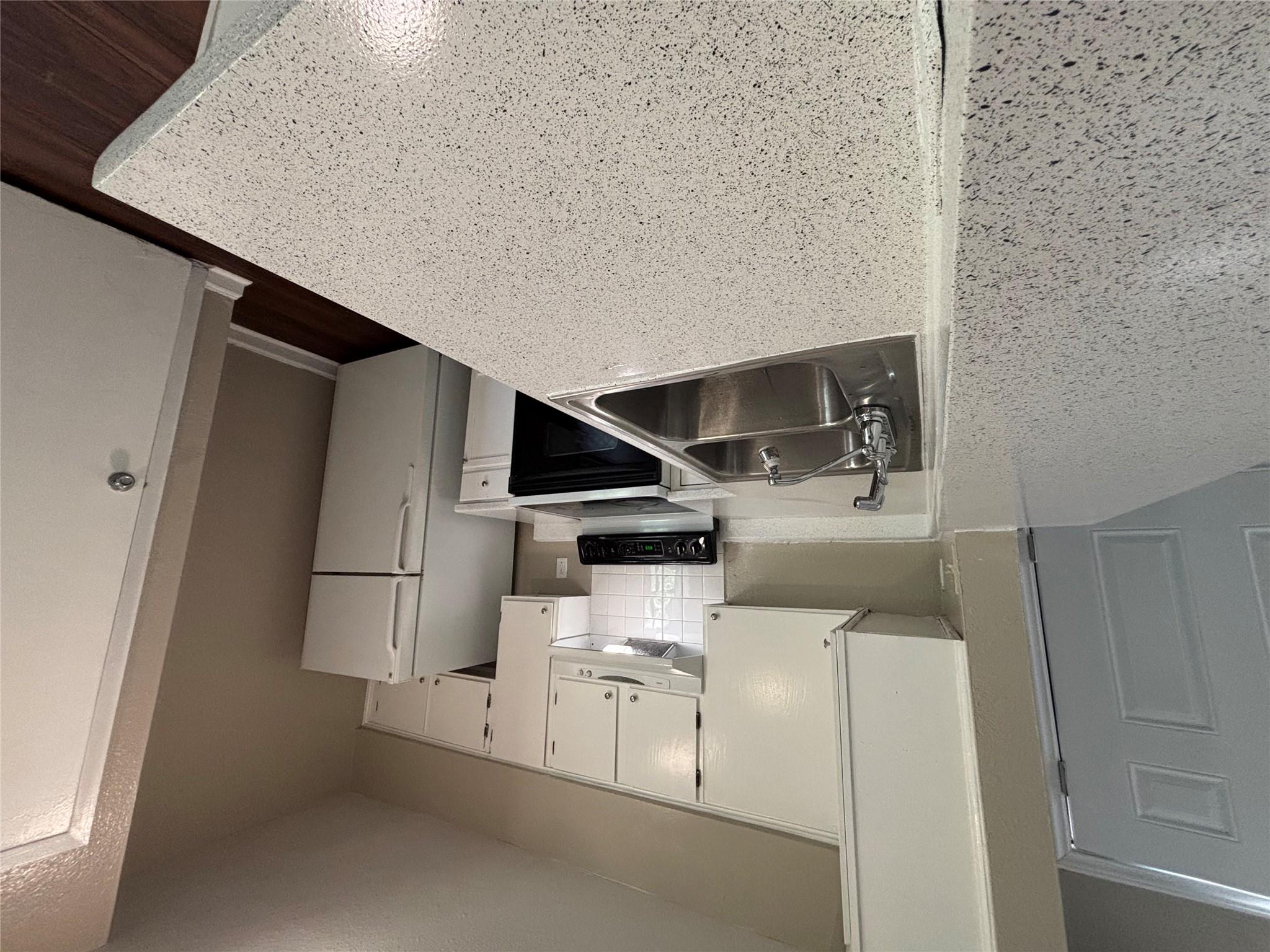 A well-appointed kitchen features ample counter s