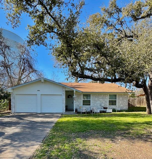 A classic ranch-style home featuring a two-car ga