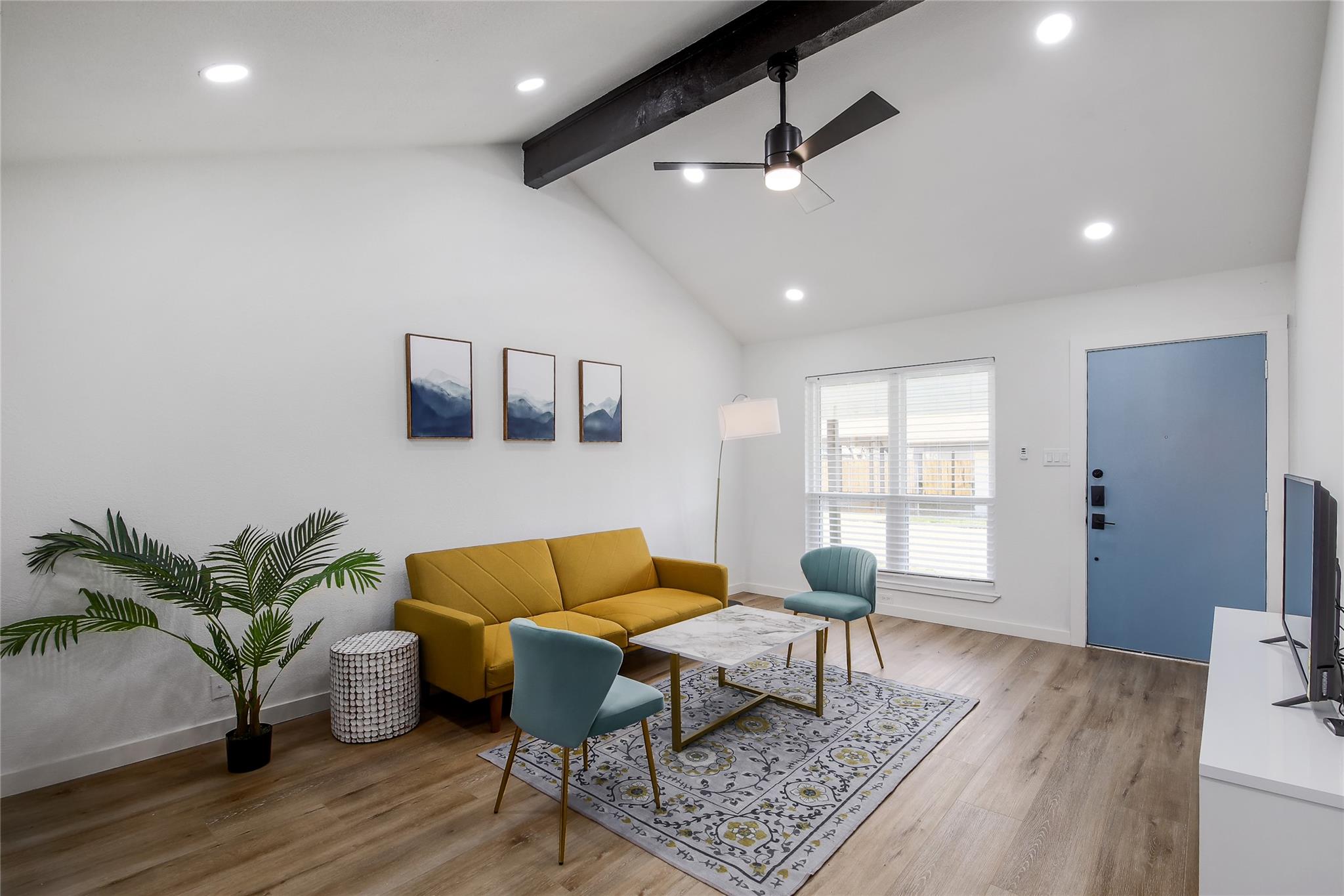 A well-lit living area features vaulted ceilings 