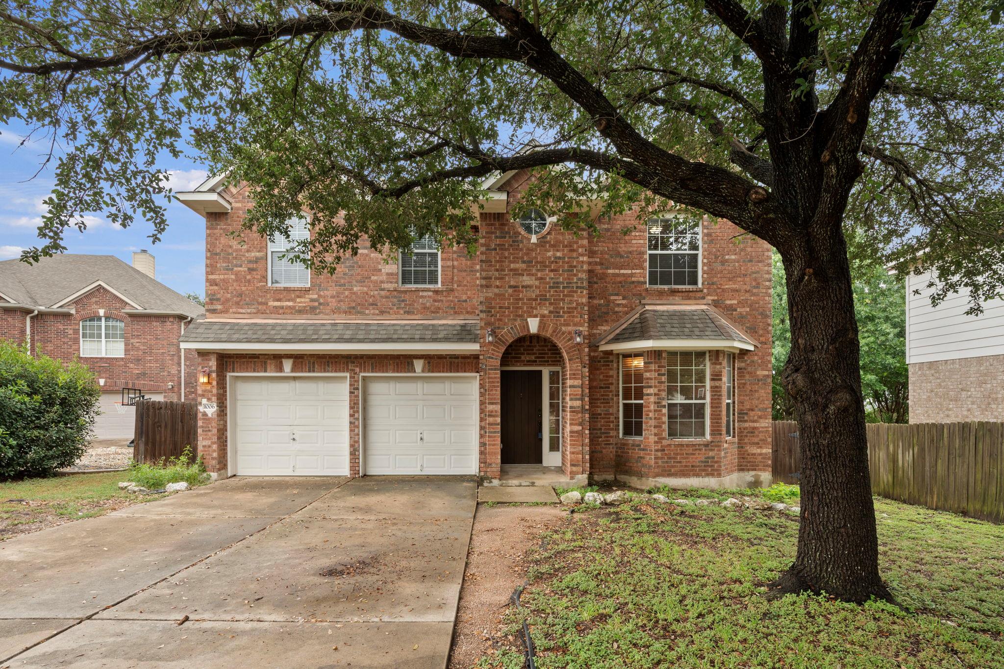 A classic brick-front home features a two-car gar