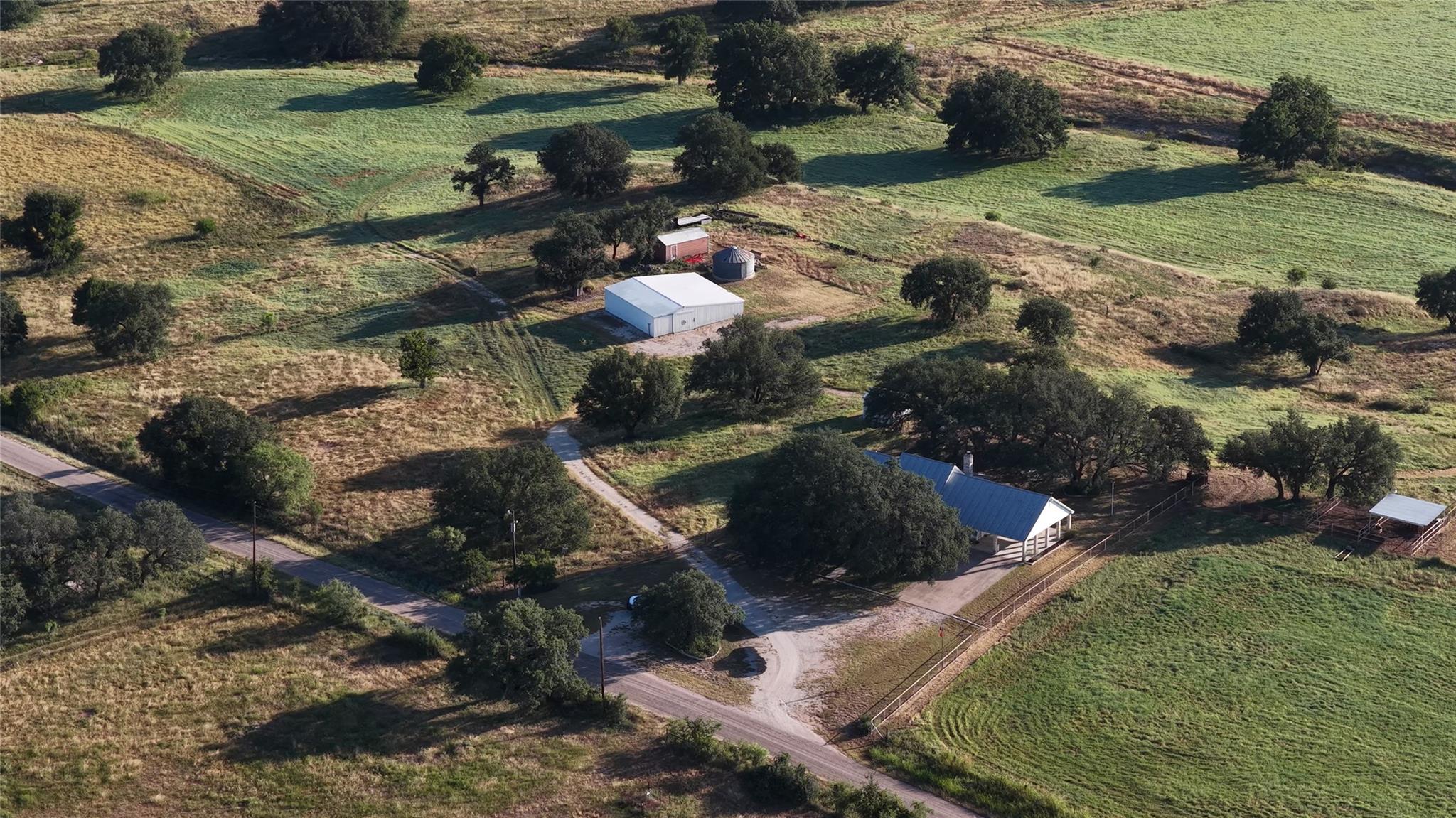 Rolling hills and mature trees frame this expansi