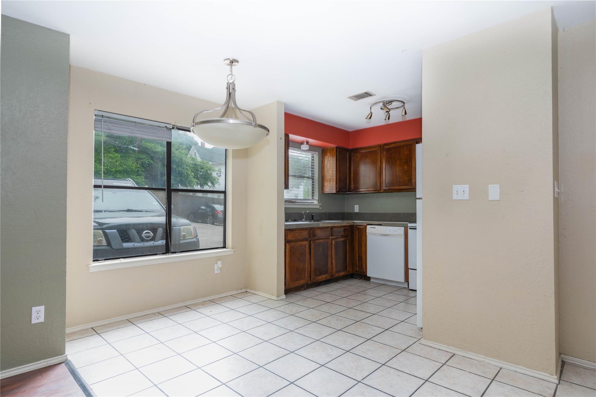 A well-lit kitchen and dining area features rich 