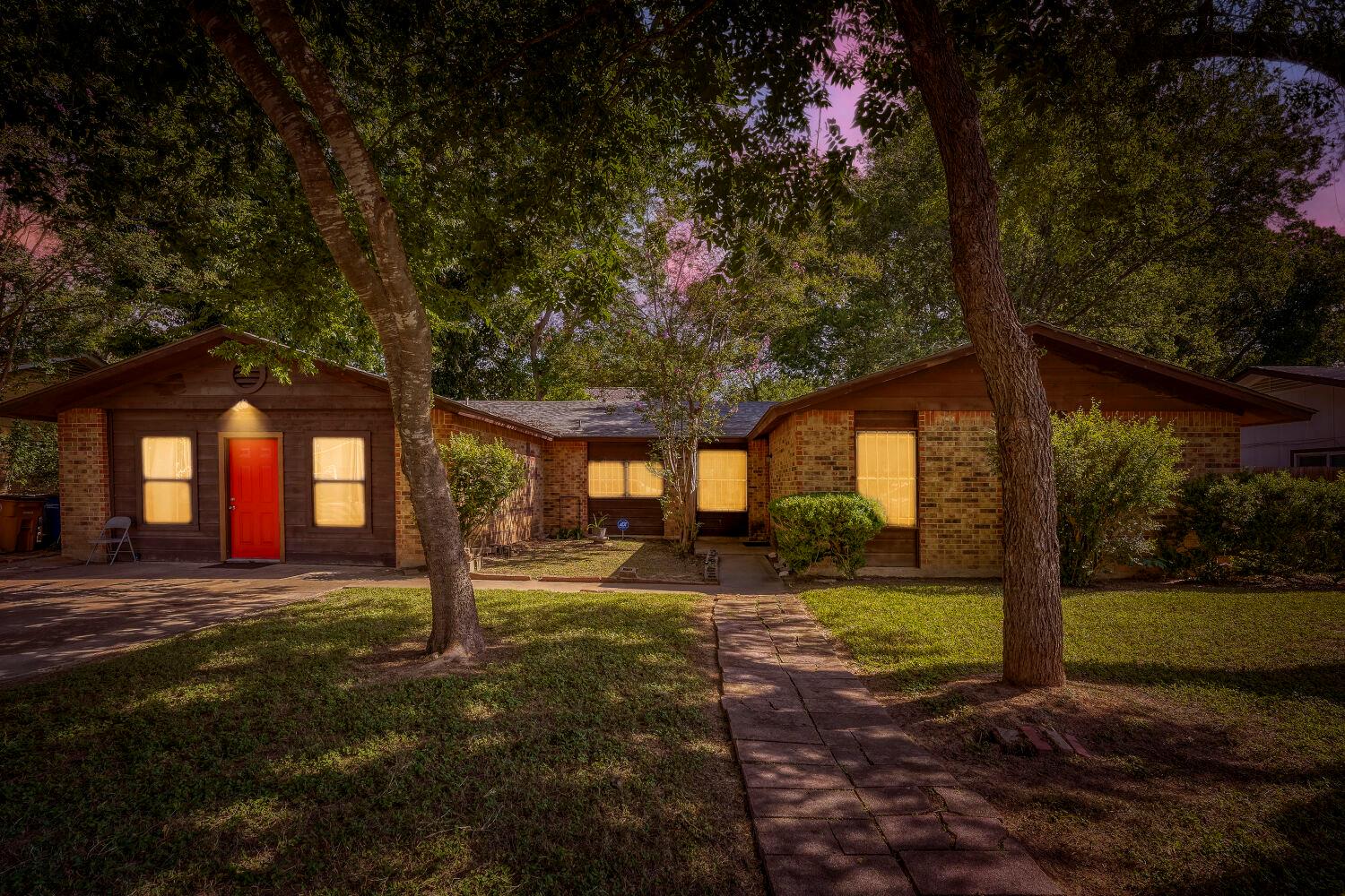 Mature trees shade this inviting brick residence,
