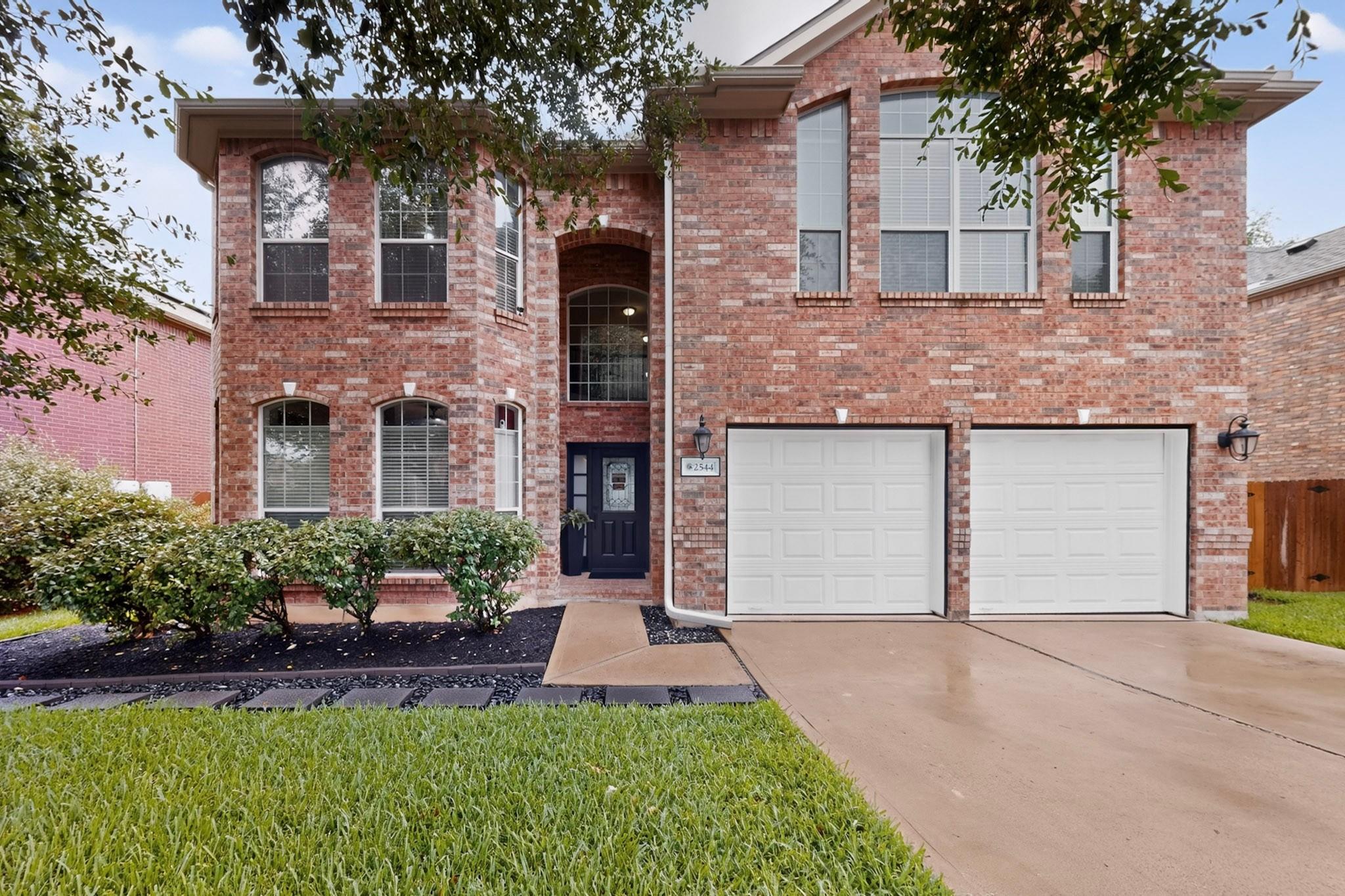 A classic brick exterior showcases a welcoming en