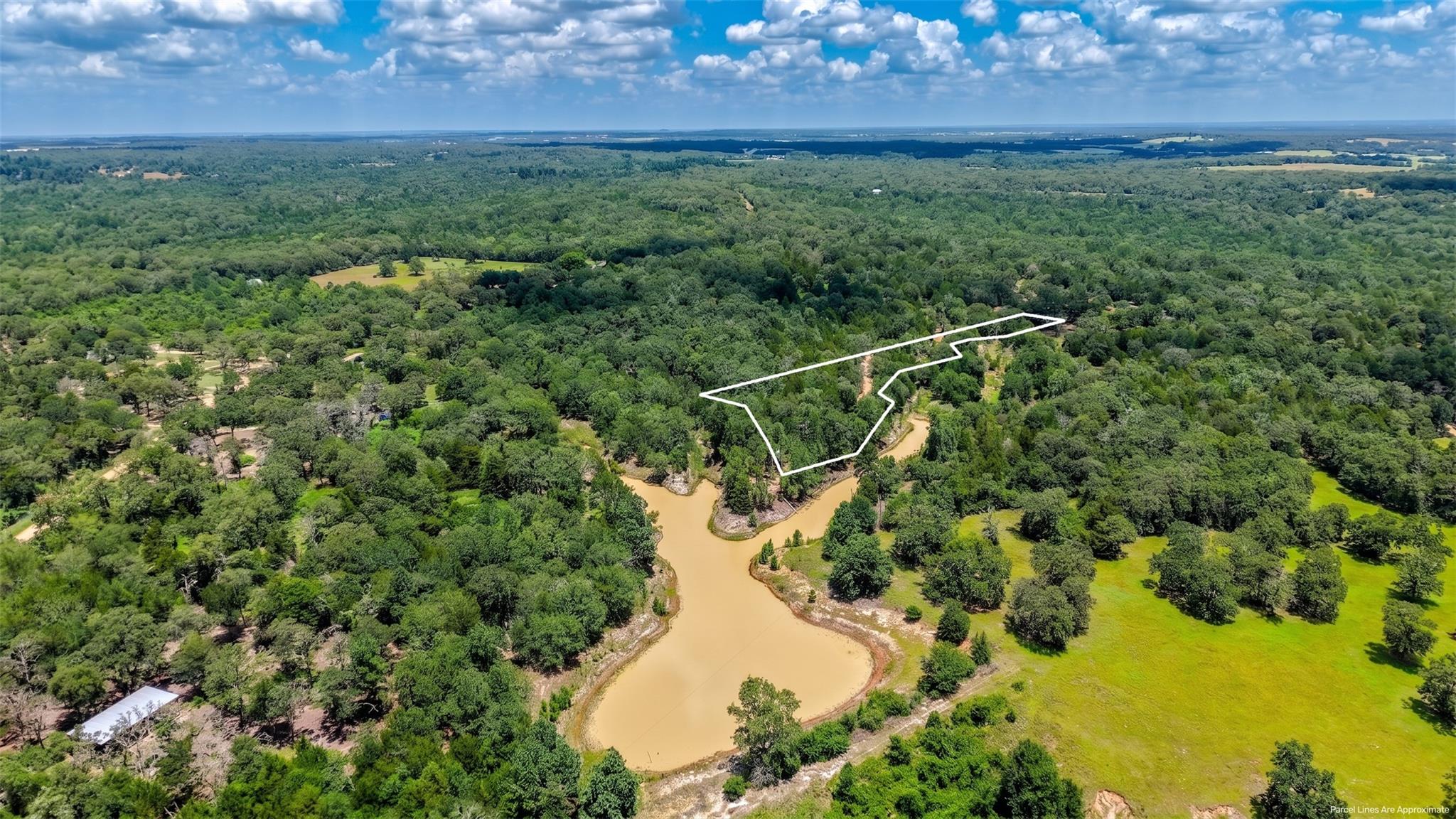 A sprawling wooded acreage includes a private pon