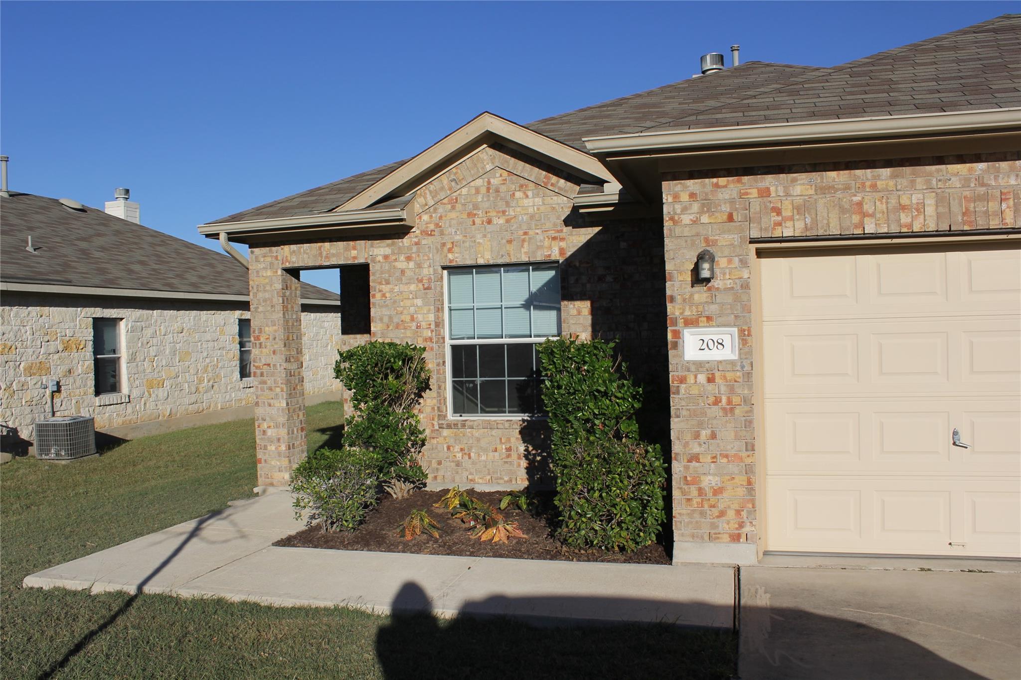 A well-maintained brick exterior highlights this 