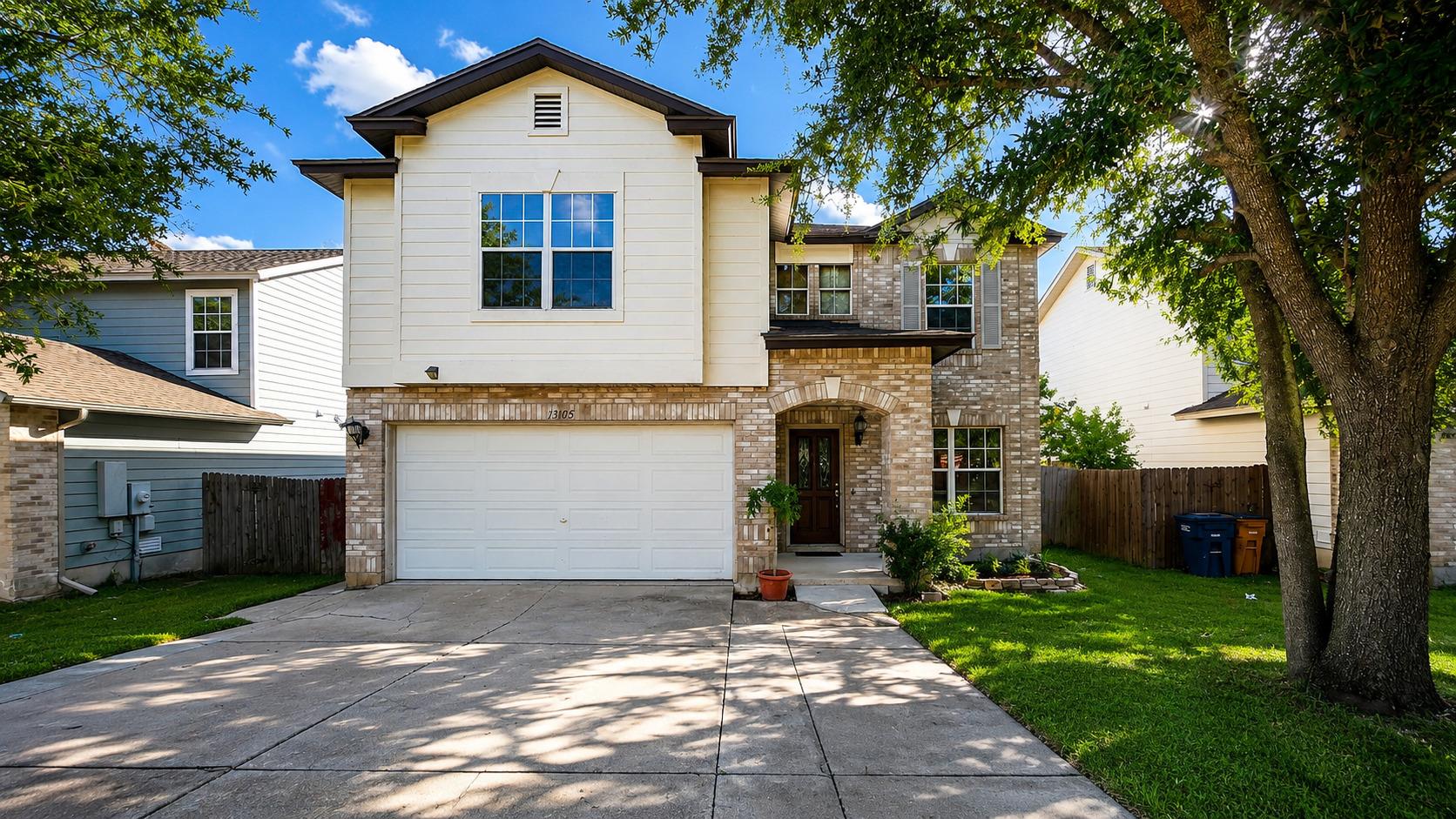 A classic two-story home features a welcoming bri