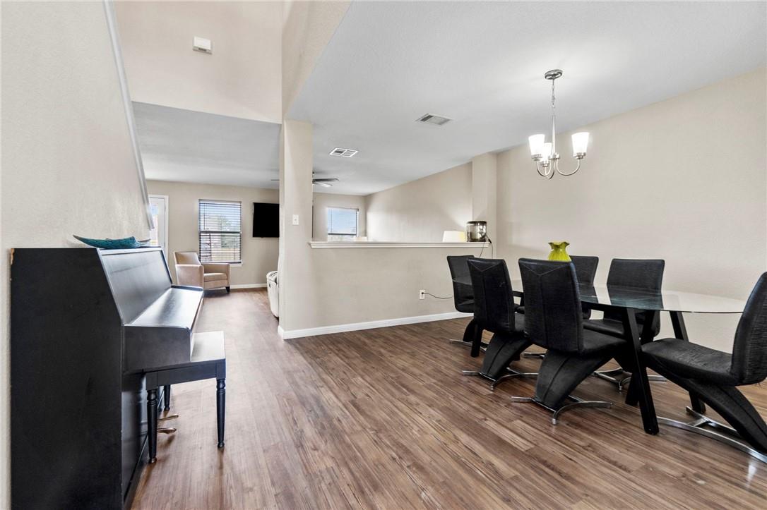 Rich wood-toned flooring extends through this ope