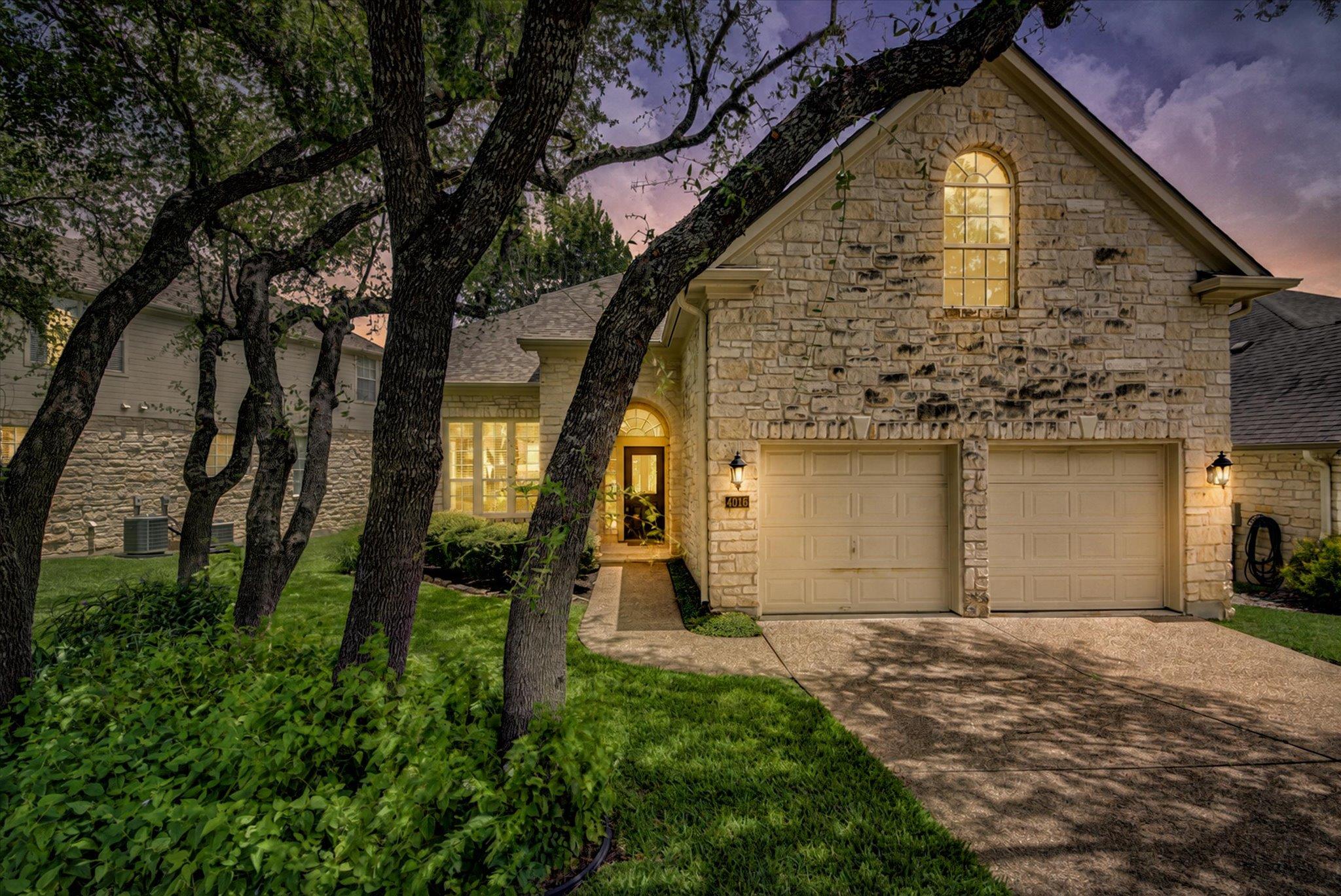 A charming stone facade home greets guests with a