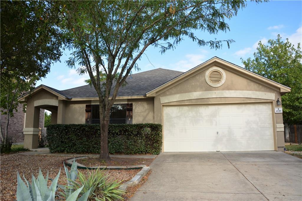 A well-maintained stucco home with an attached ga