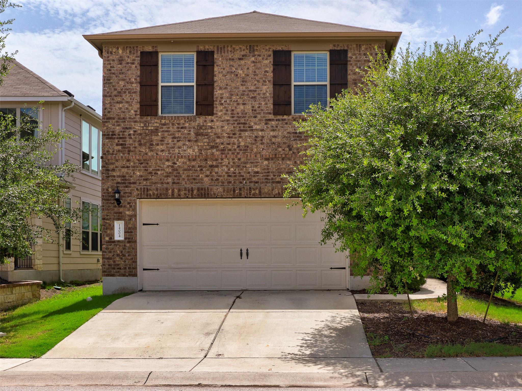 A well-maintained brick facade and a two-car gara