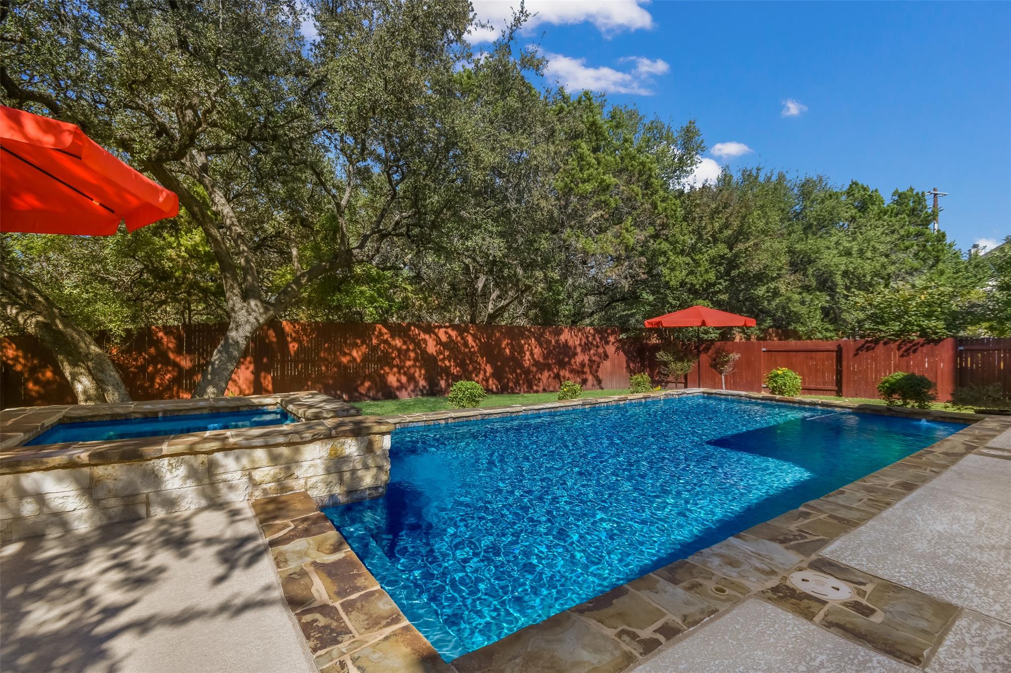 A private backyard oasis features a shimmering po