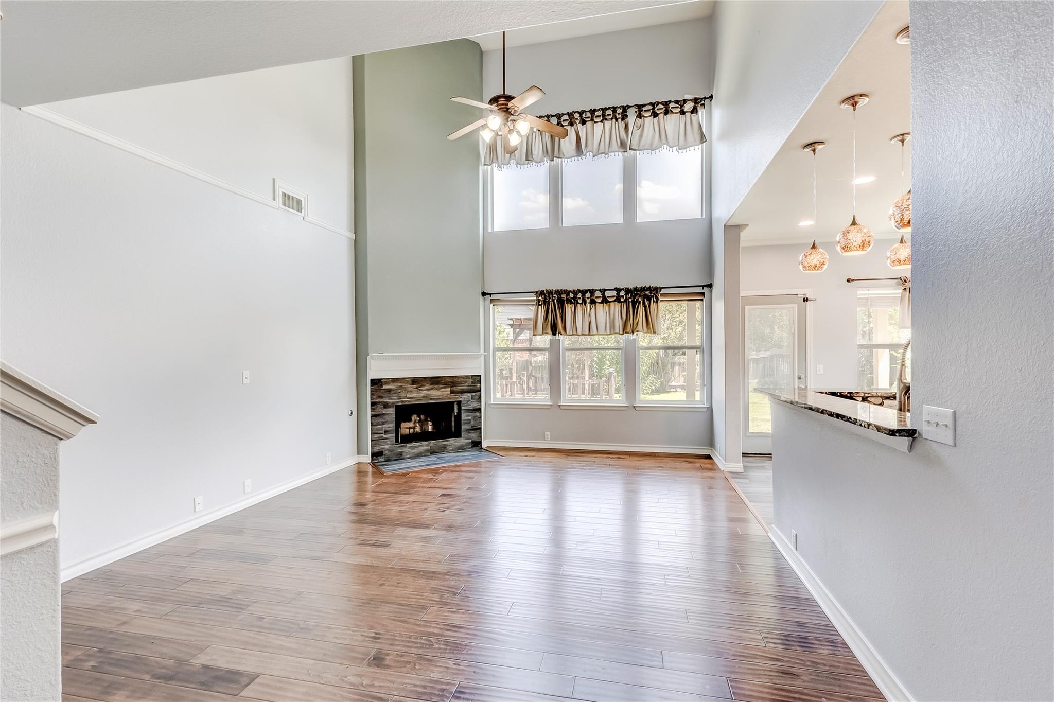 A spacious living area features high ceilings, a 