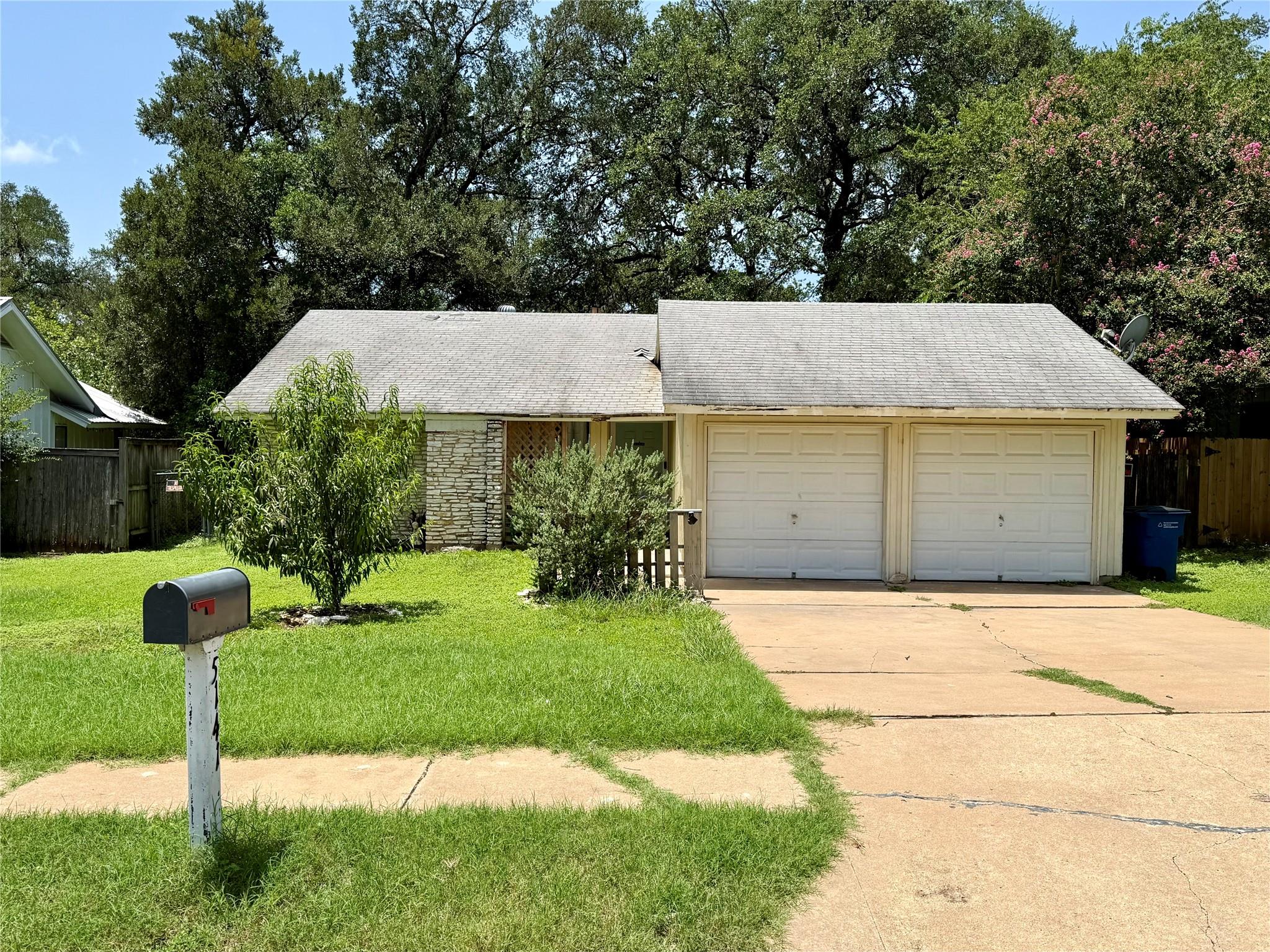 A classic ranch home presents with a two-car gara