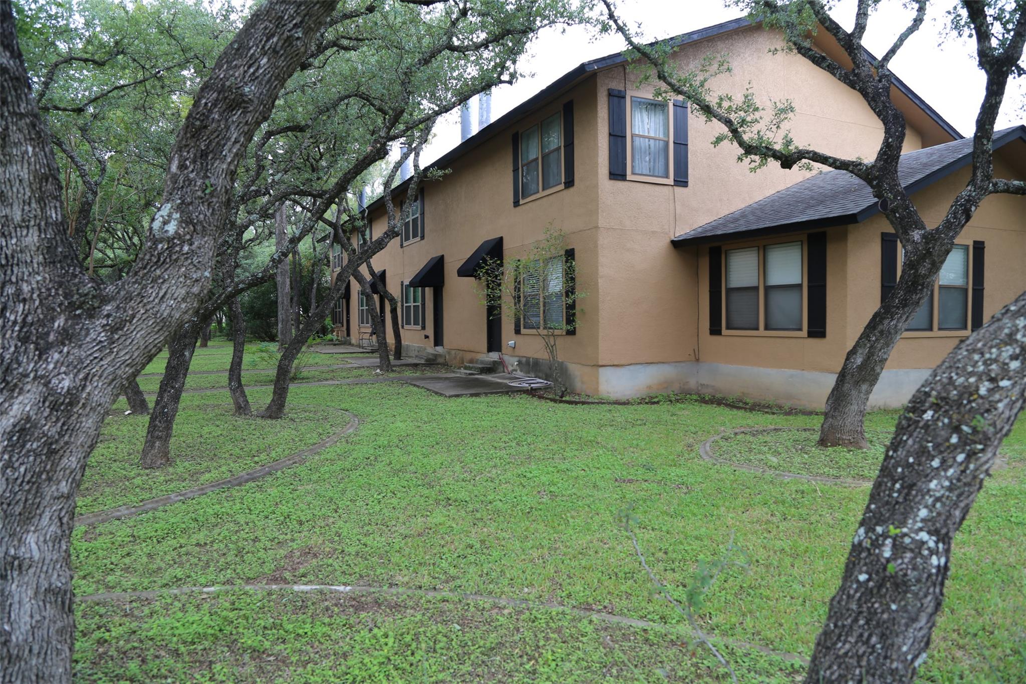 Mature trees frame this charming multi-level resi