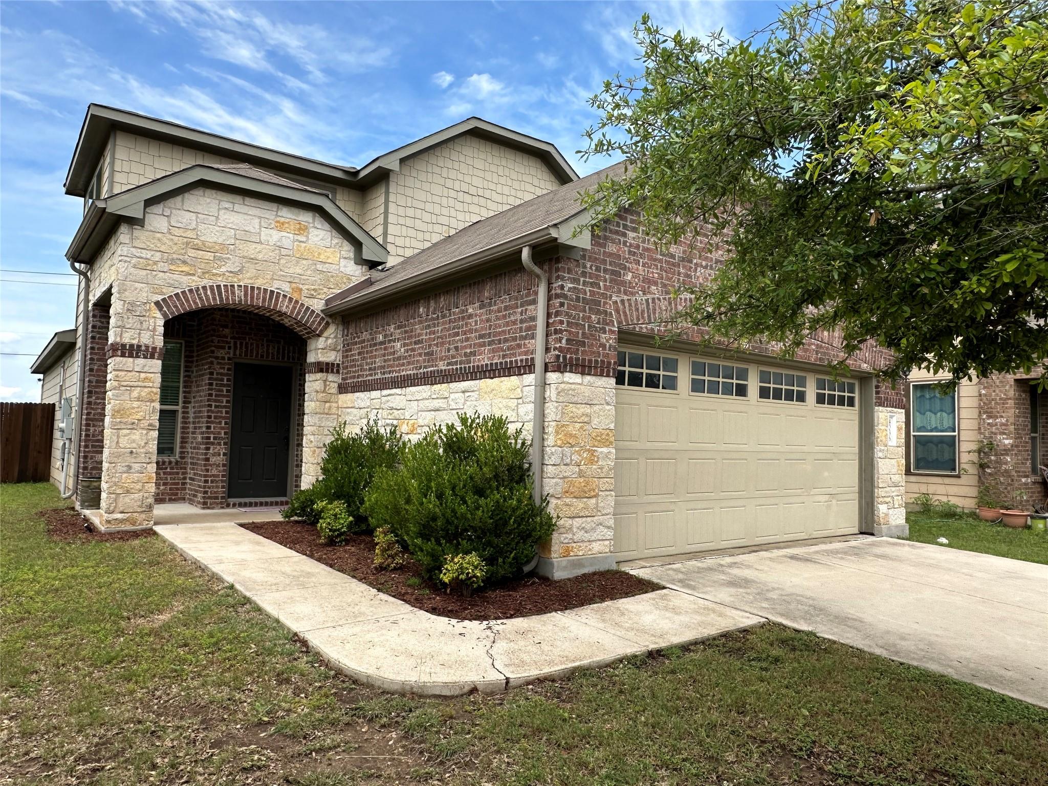 A classic brick and stone facade welcomes with an