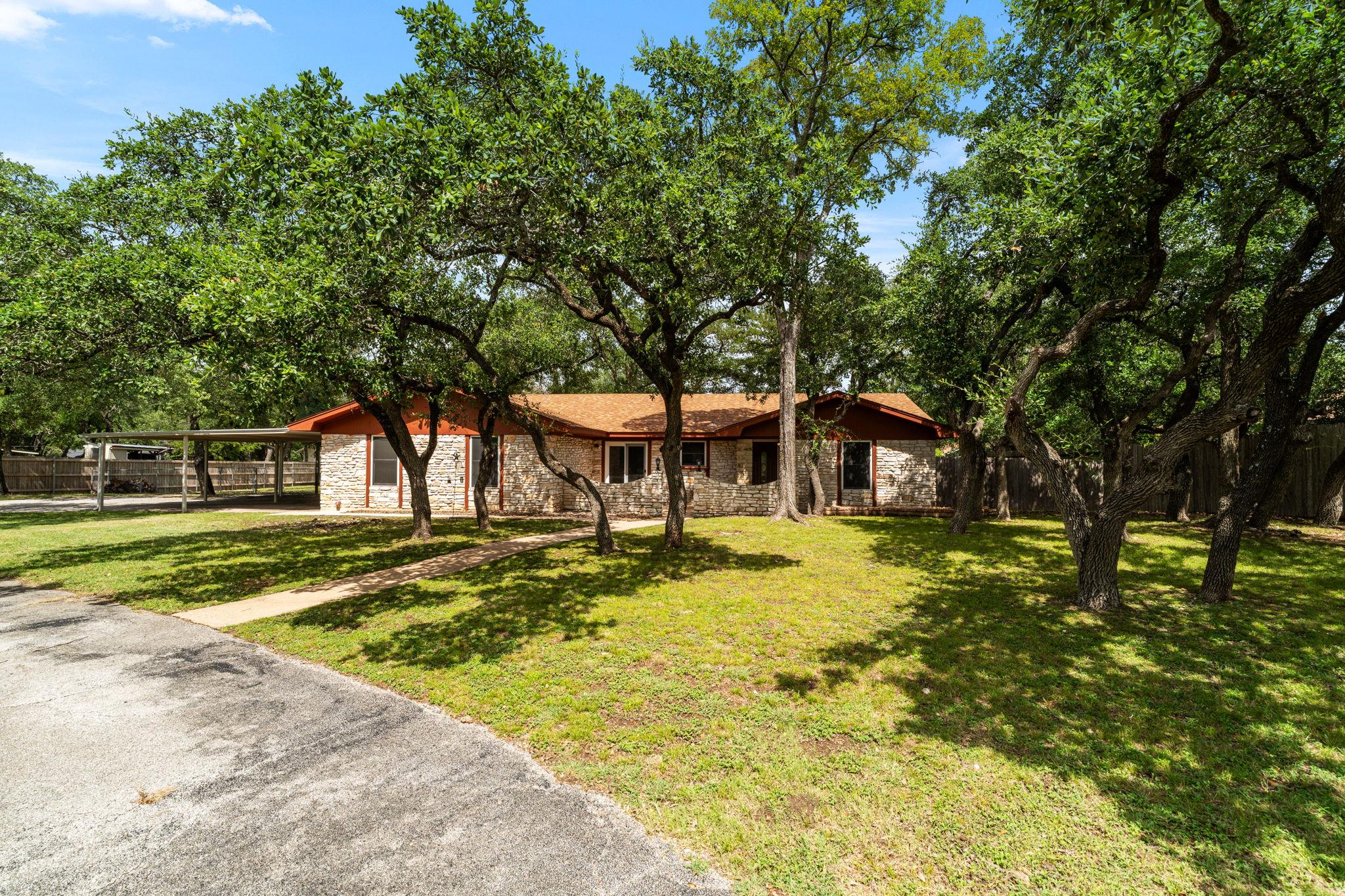 Mature trees shade this charming residence featur