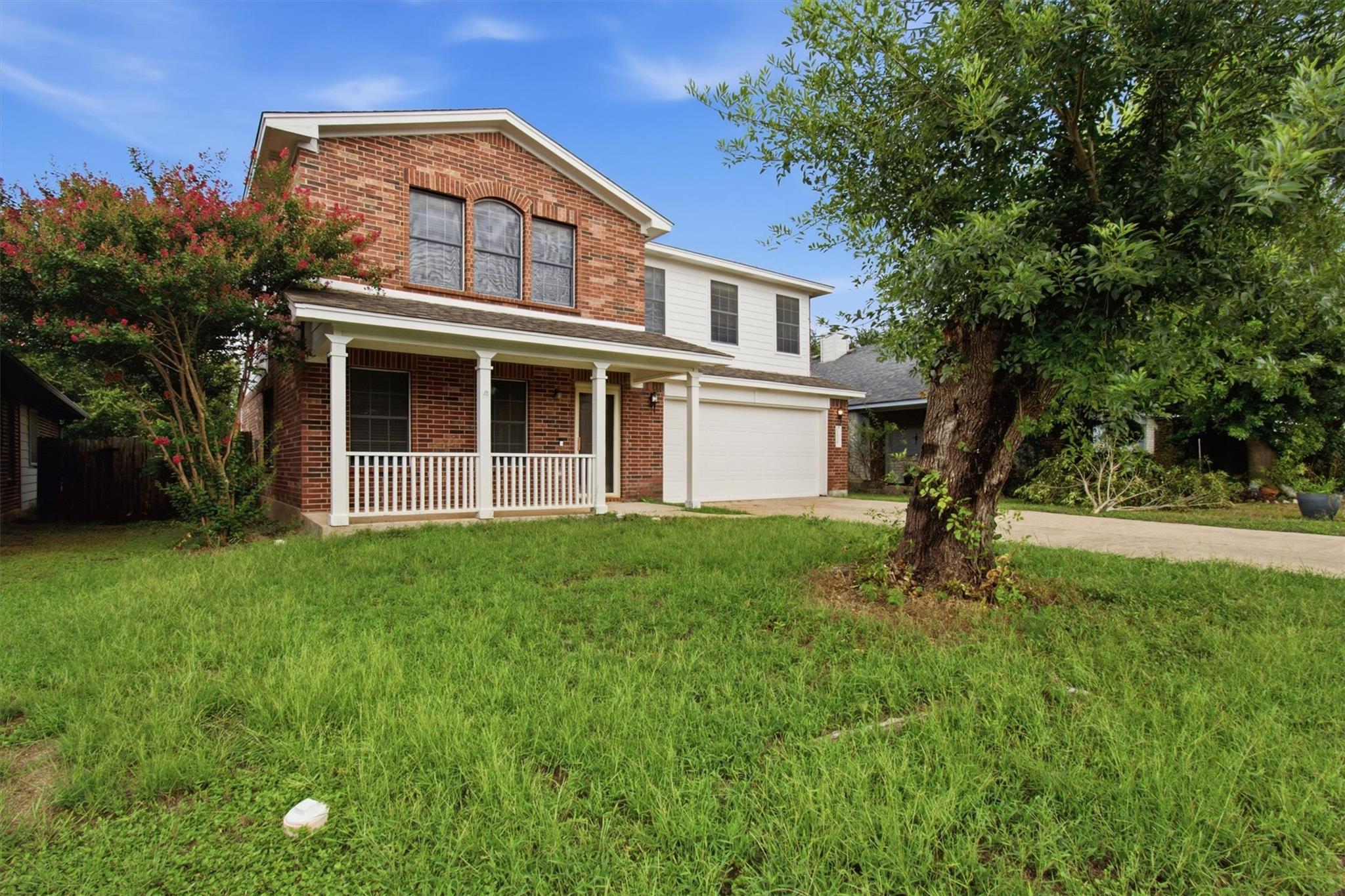 Brick facade home offers a welcoming front porch,