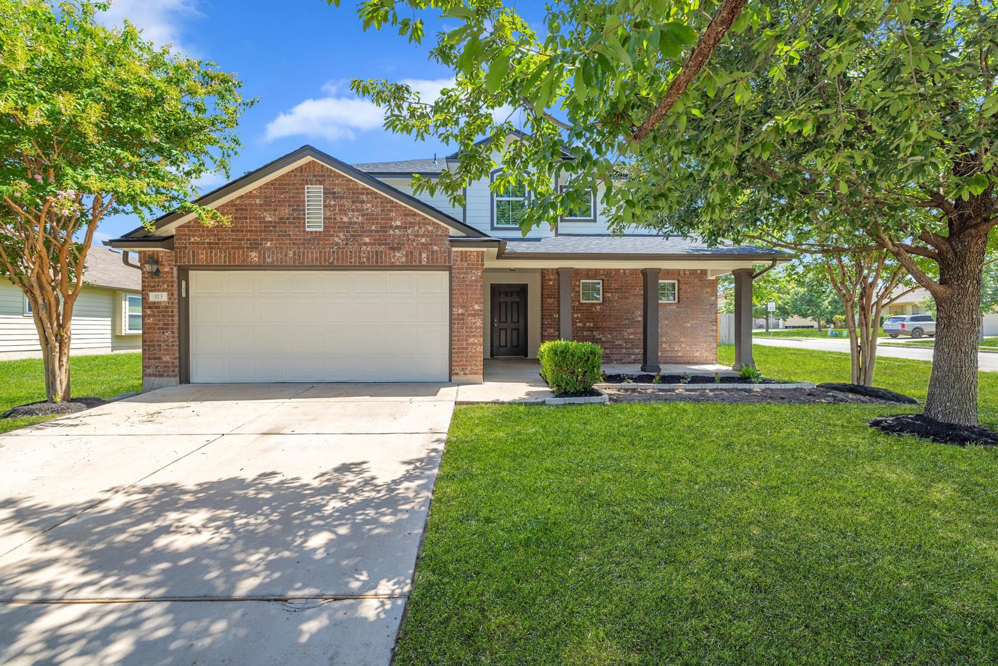 Brick facade and a welcoming covered porch define
