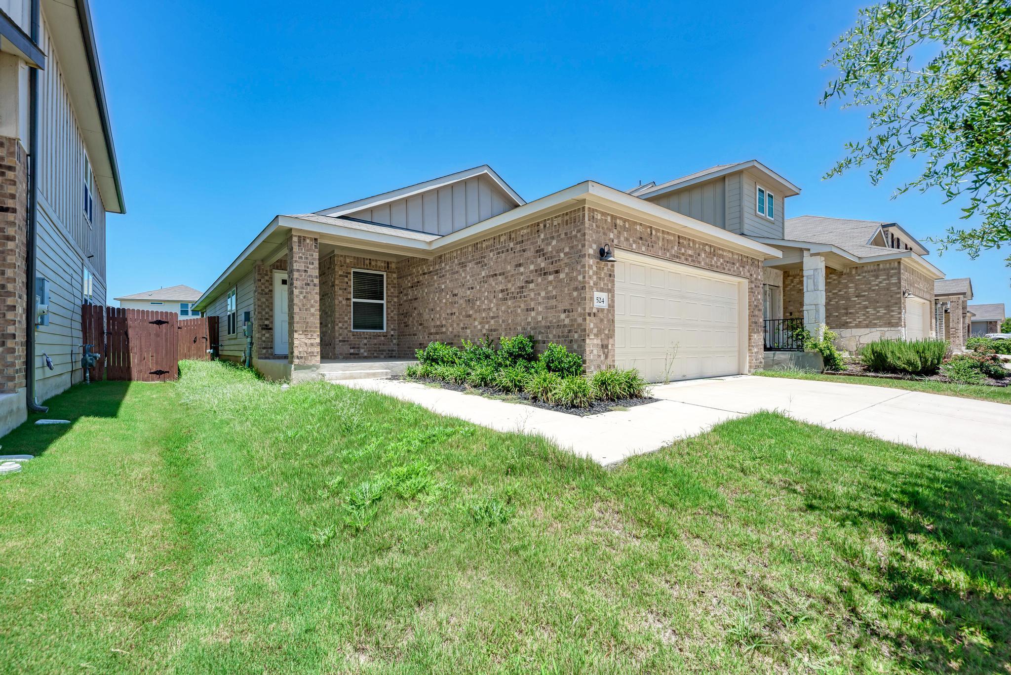 Well-maintained brick residence featuring a two-c