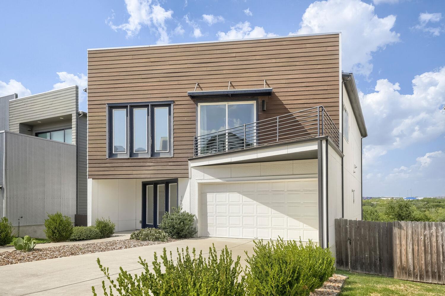 Modern architecture with wood siding and large wi