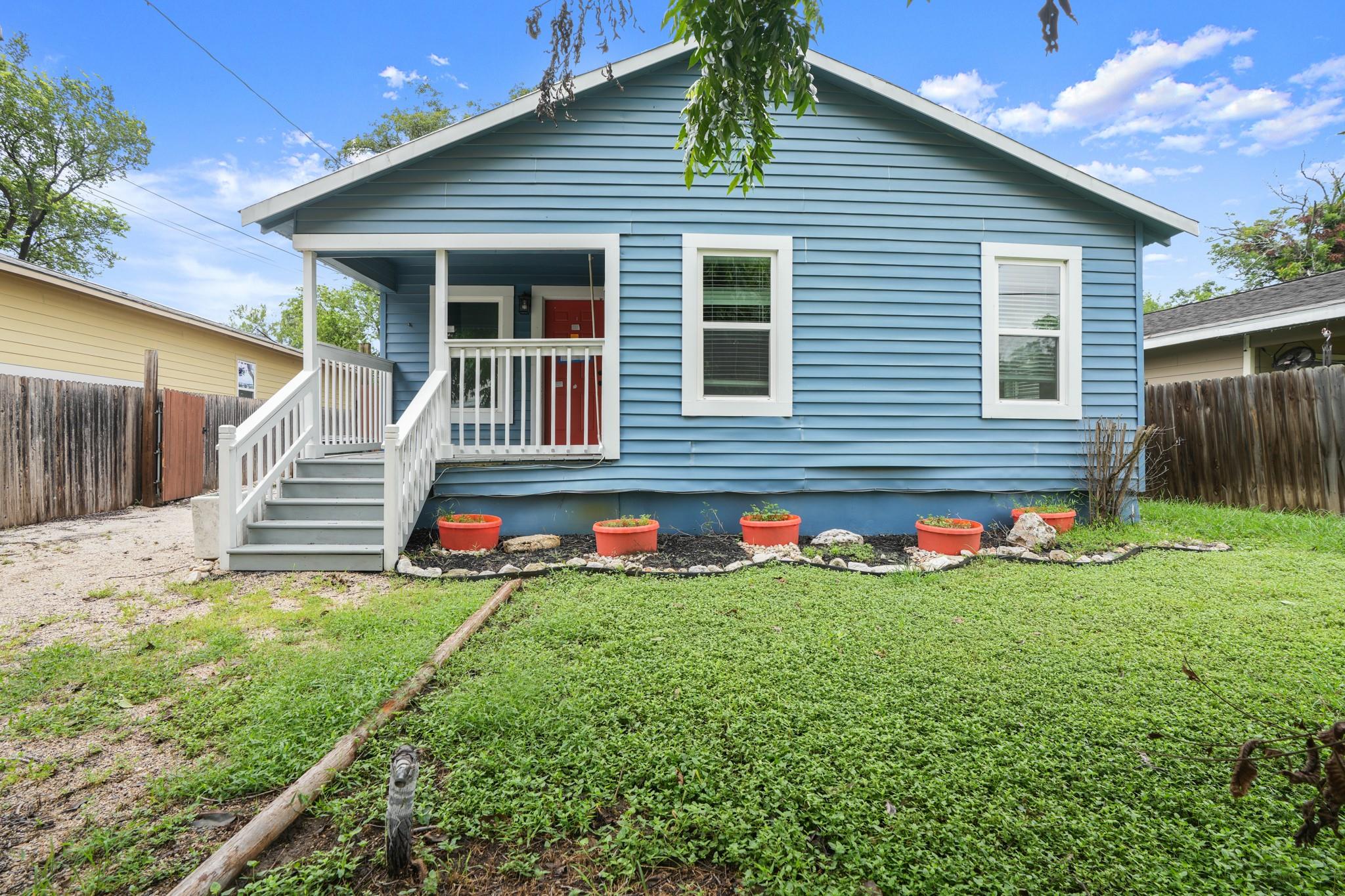 A charming blue residence with a welcoming front 