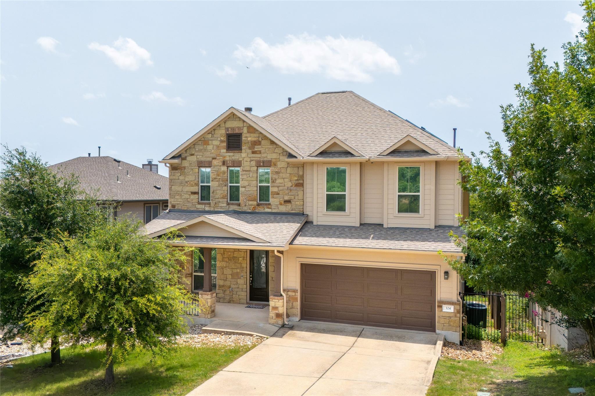 A welcoming stone and siding facade offers excell