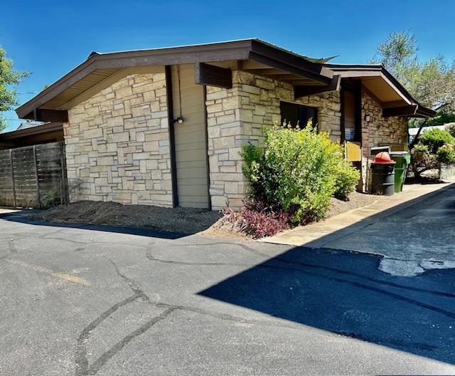 View of side of home featuring stone siding