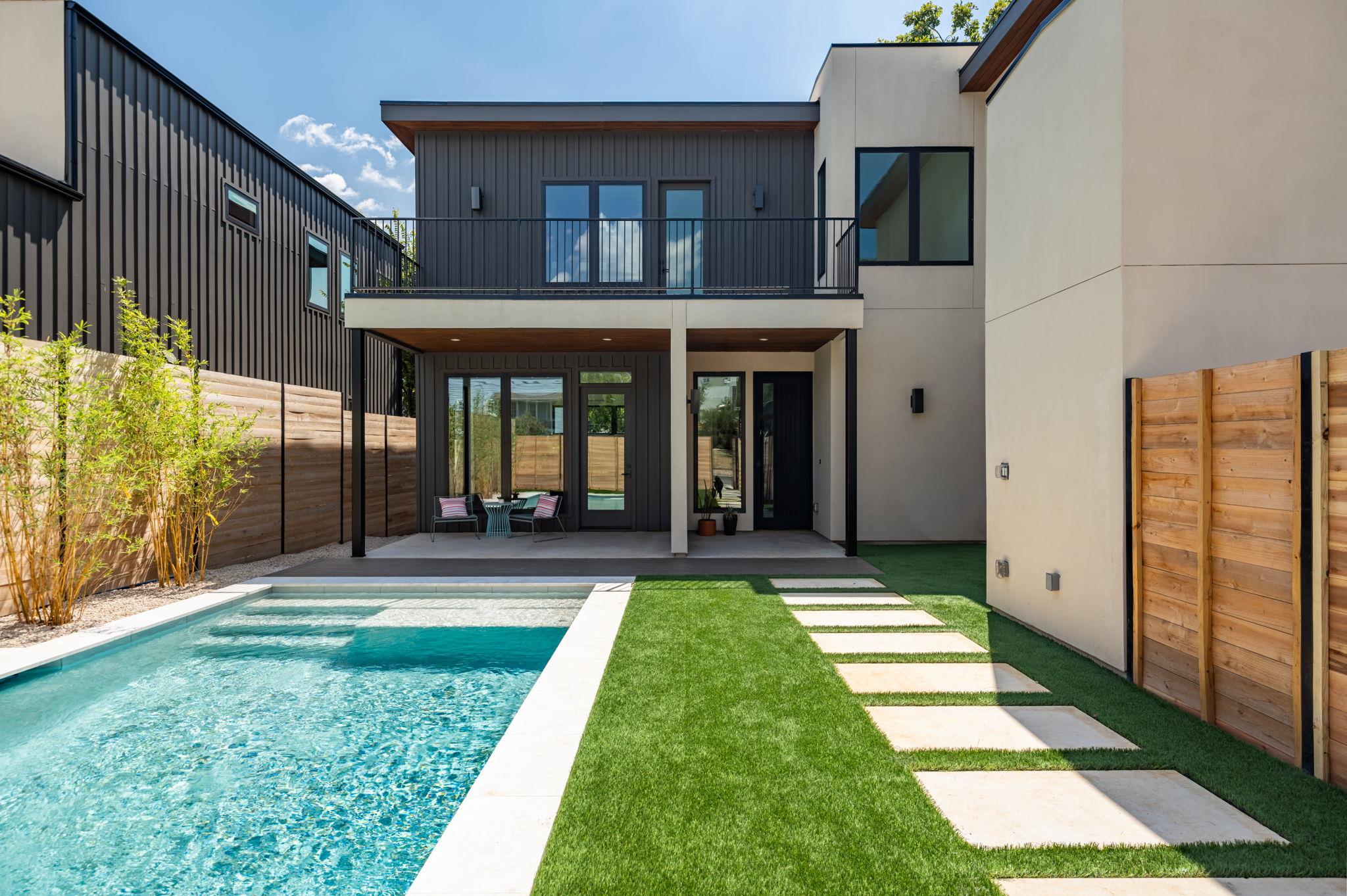A sparkling in-ground pool anchors the manicured 