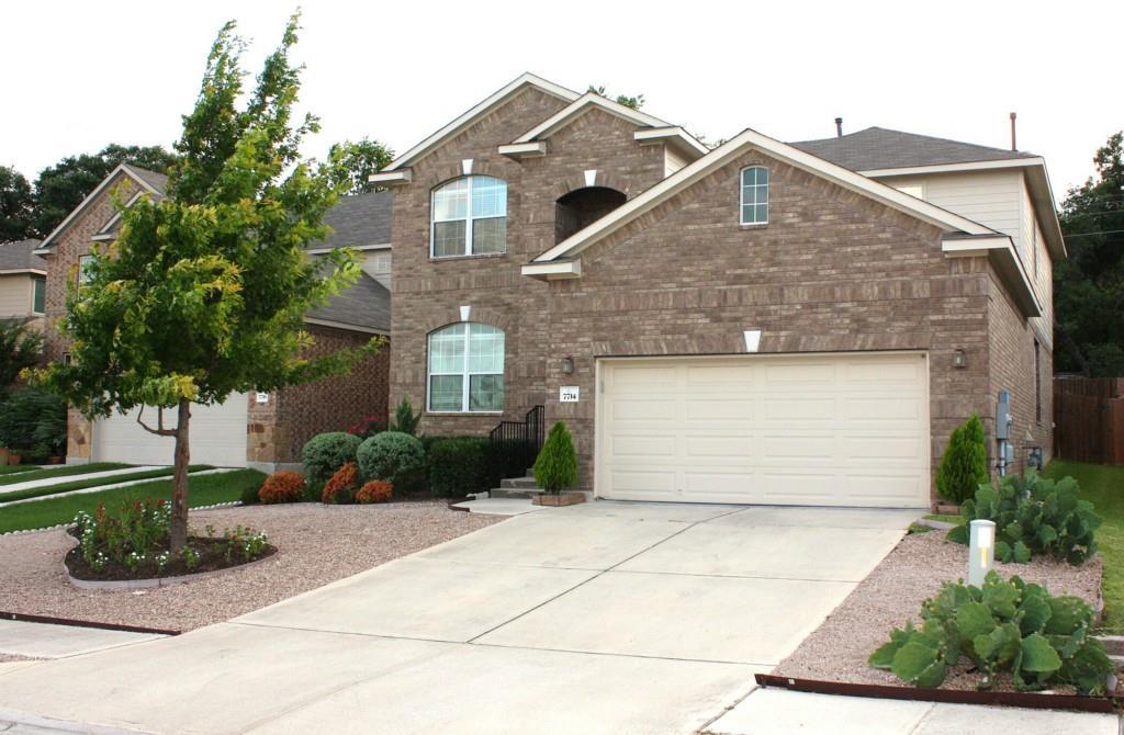 Brick facade home featuring an attached garage an