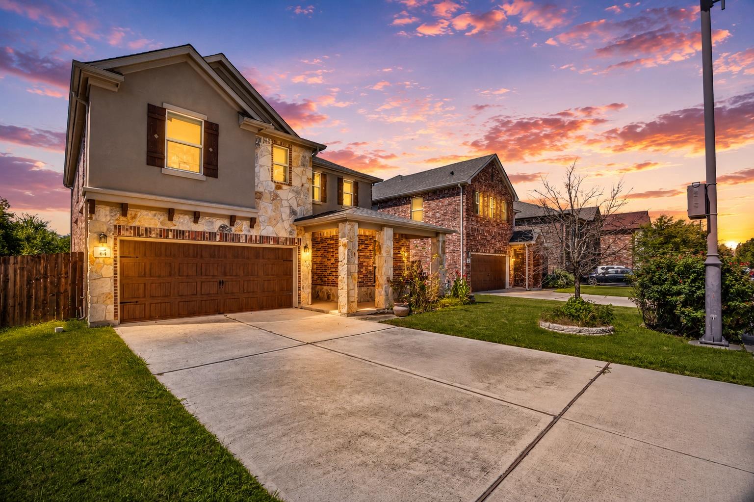 Stone and brick facade residence with a two-car g