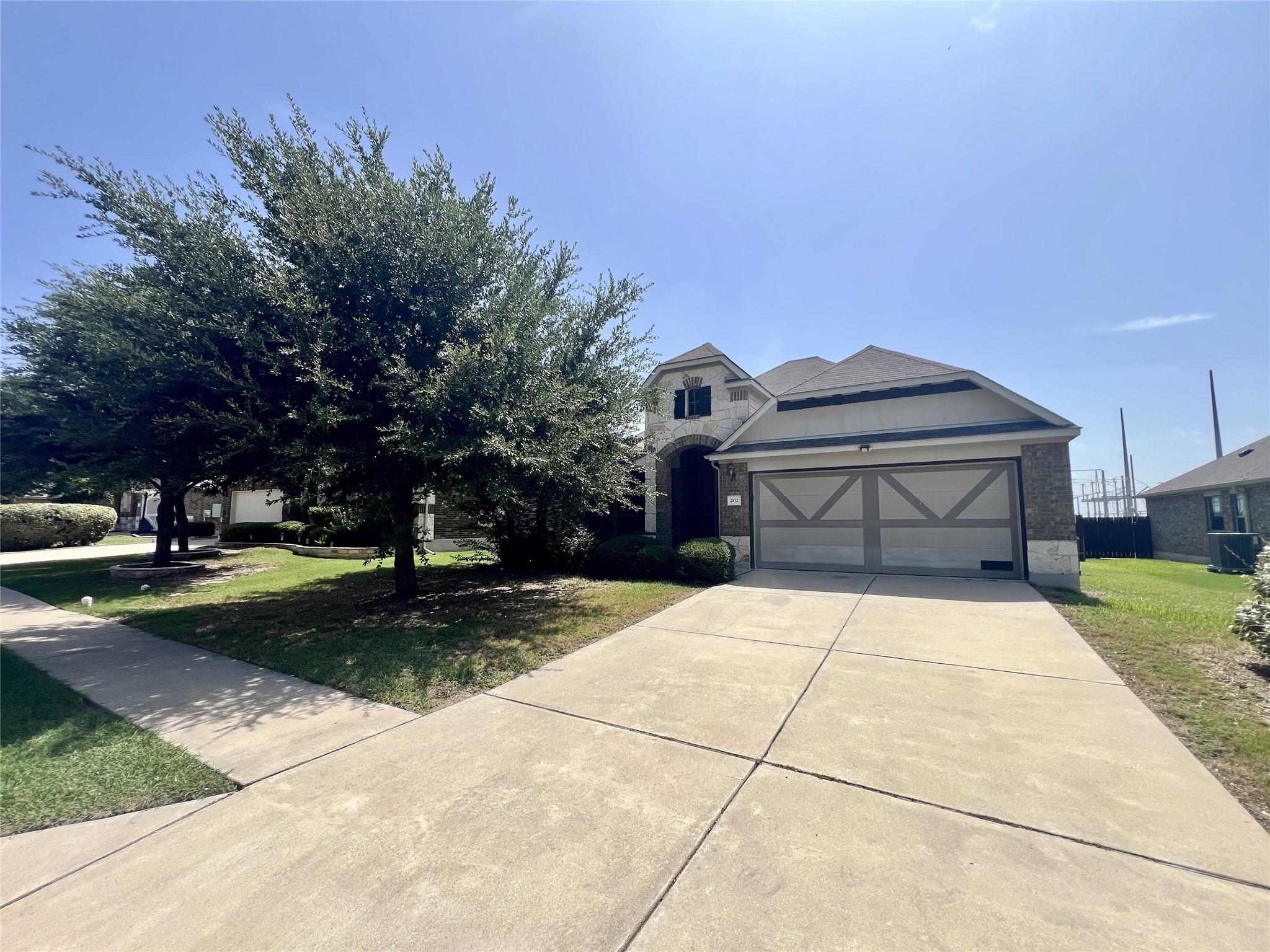 A well-maintained concrete driveway leads to a ch