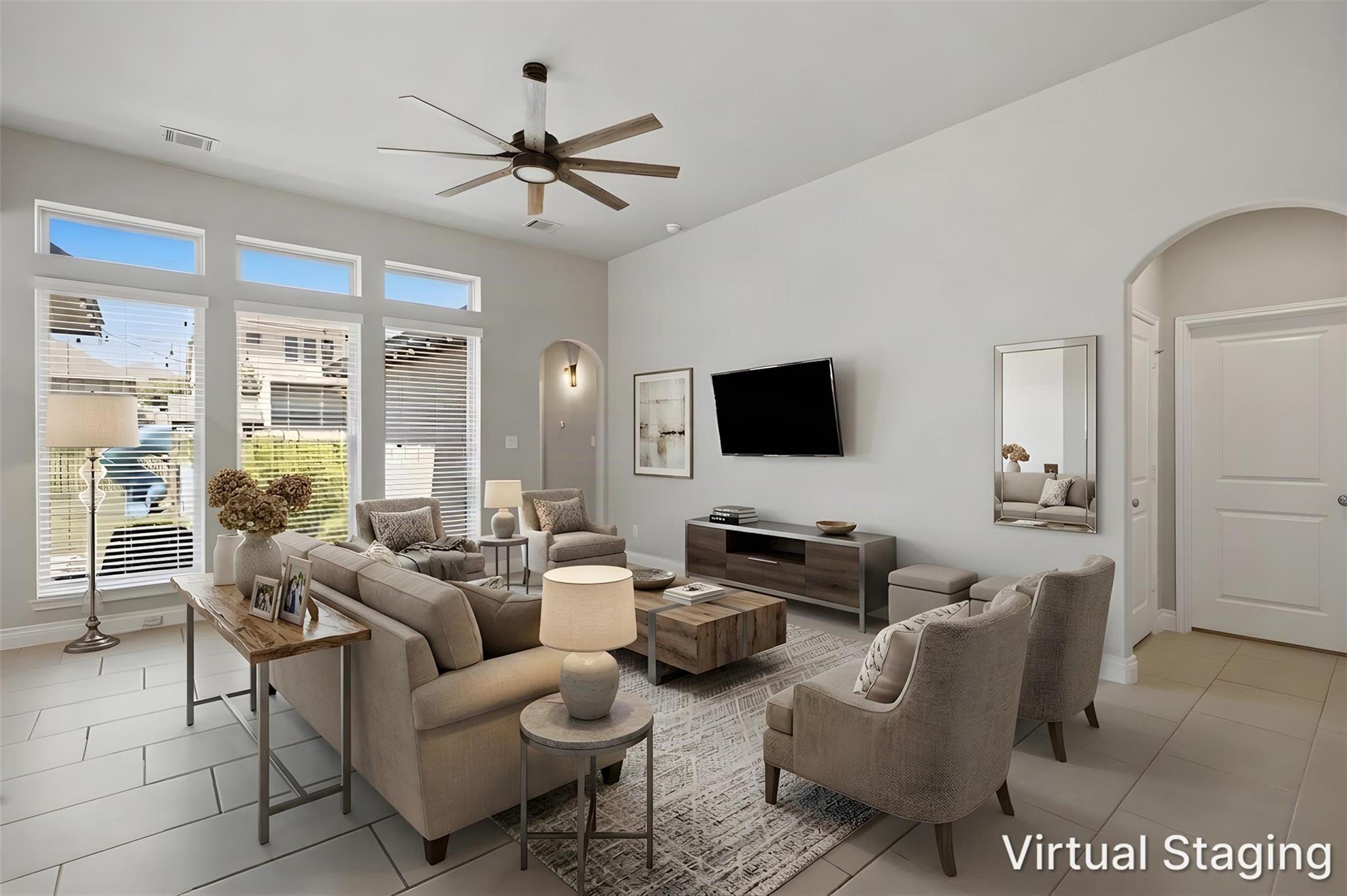 A contemporary living area presents soaring ceili