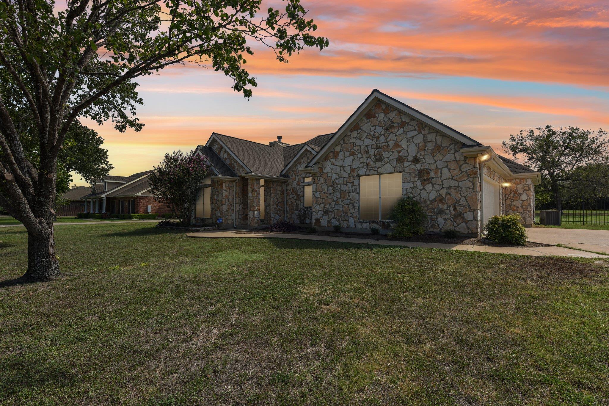 A textured stone facade under gabled rooflines an