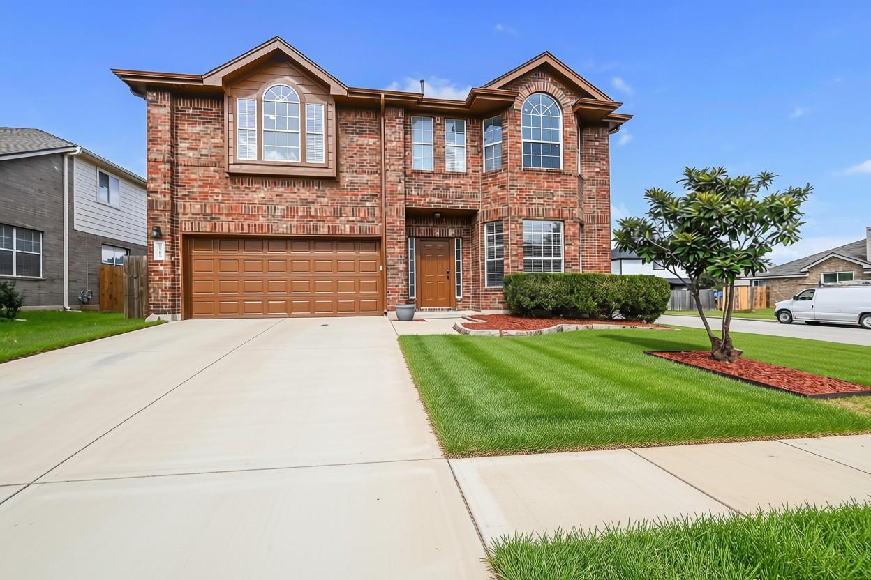 A classic brick exterior with an attached garage 