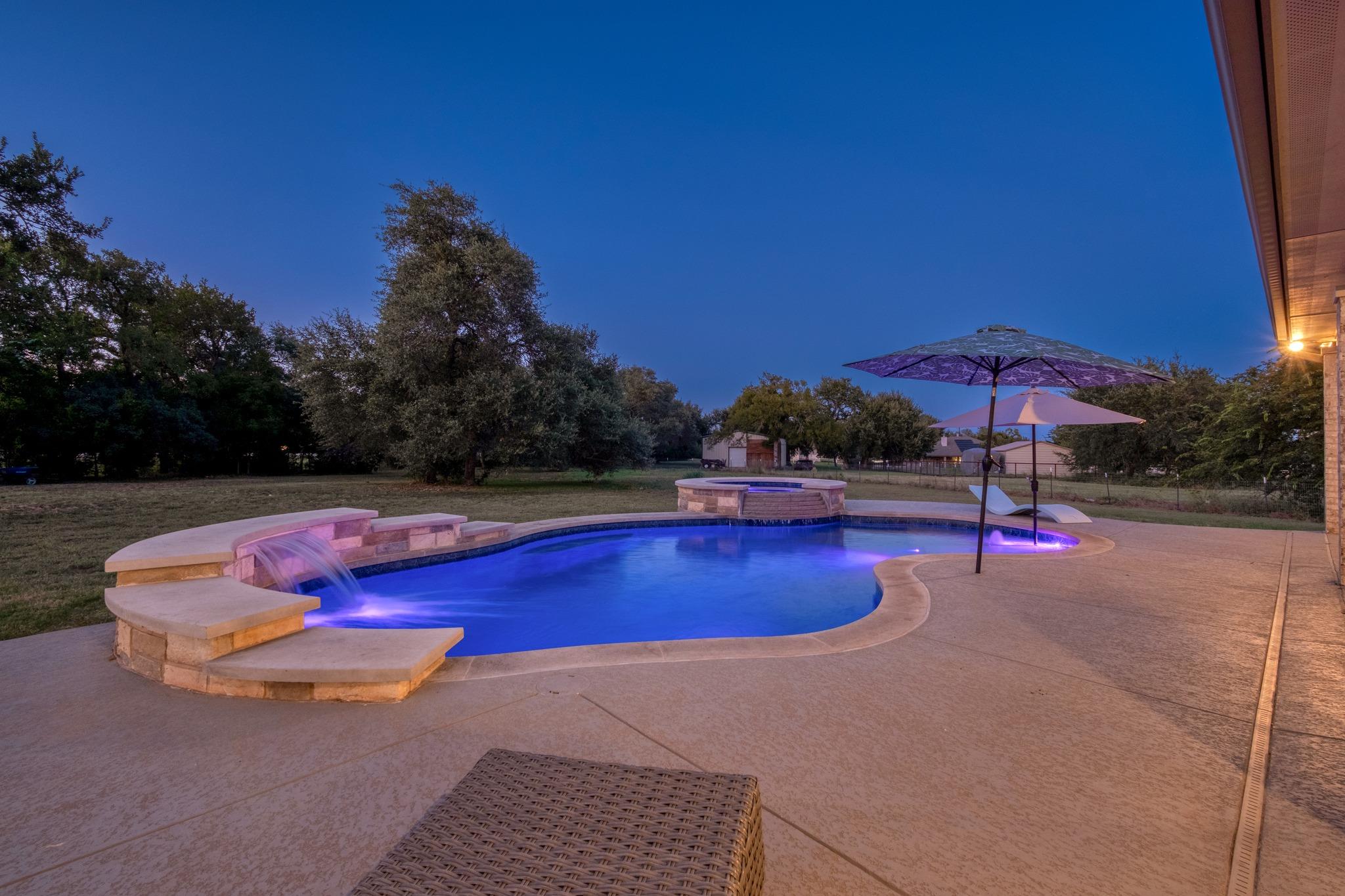 An inviting backyard oasis offers a sparkling in-