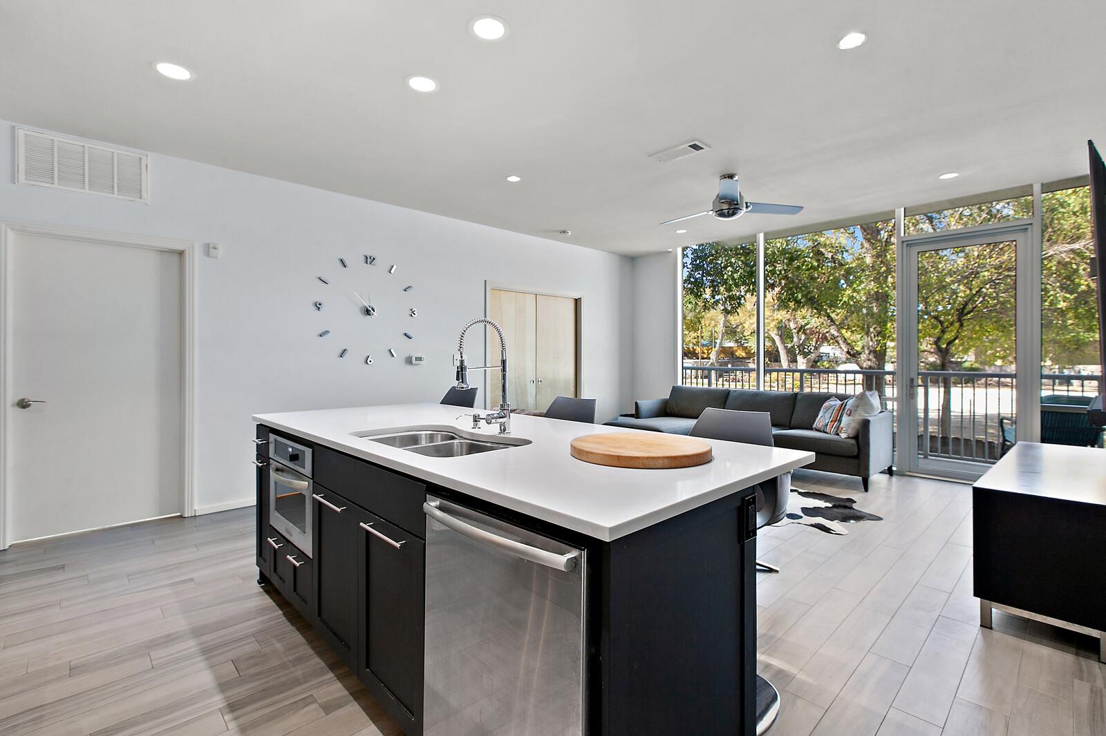An open concept kitchen features an island with b