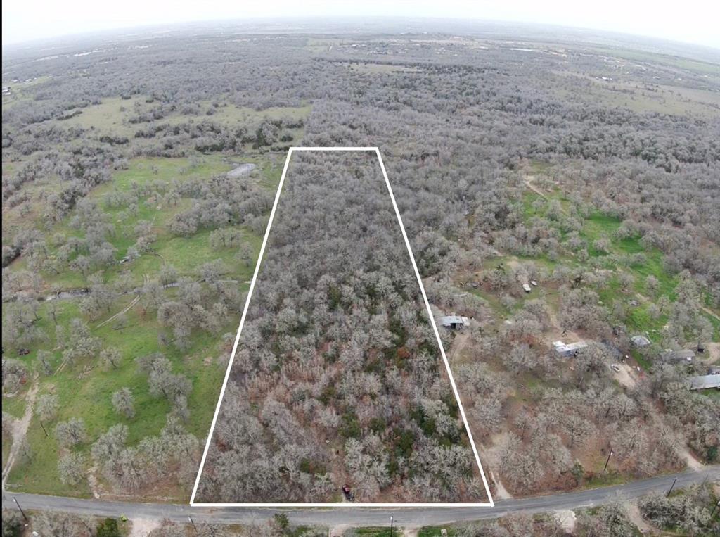 A spacious, wooded acreage offers a serene natura