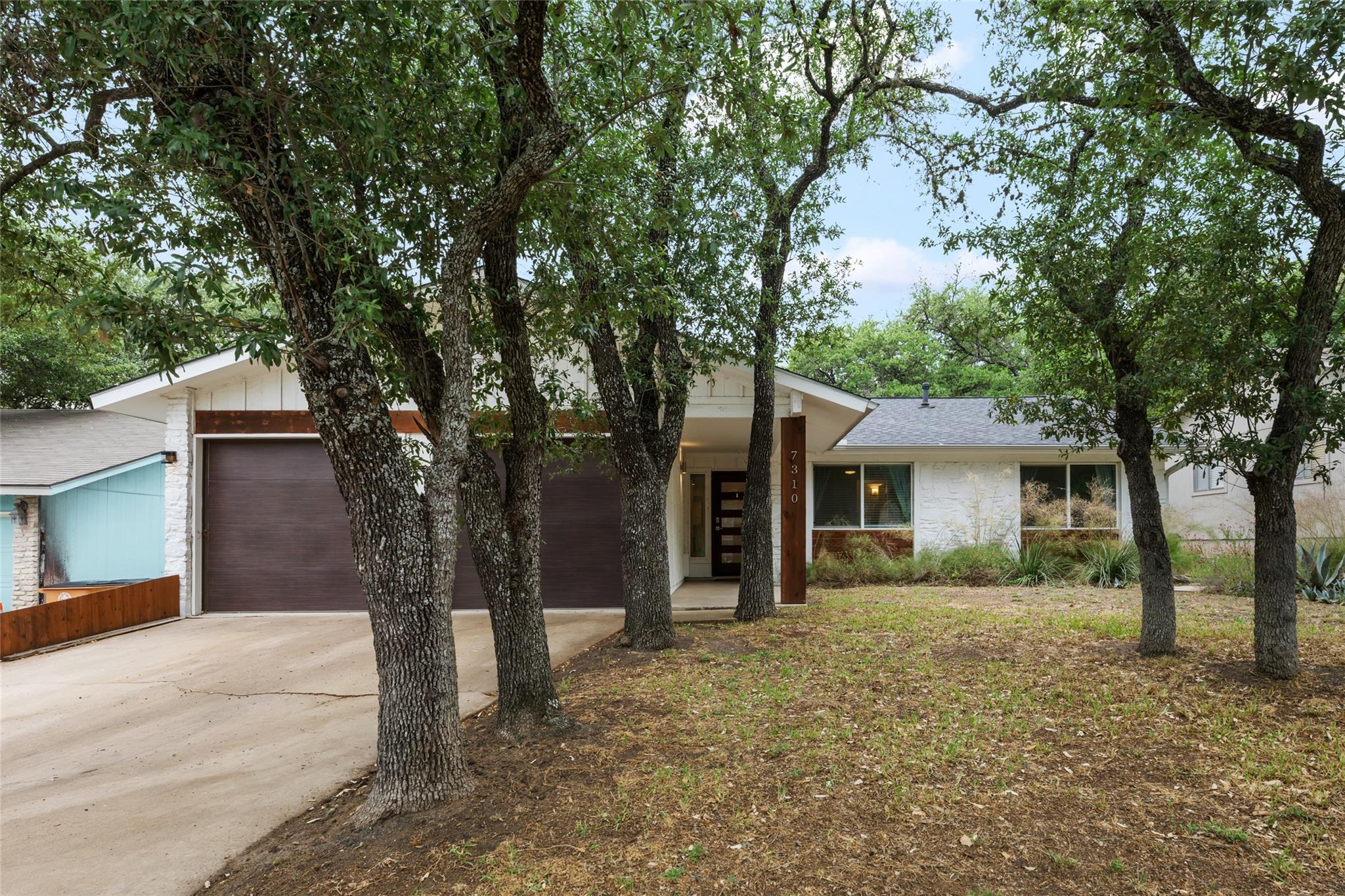 View of front of property featuring driveway, a g