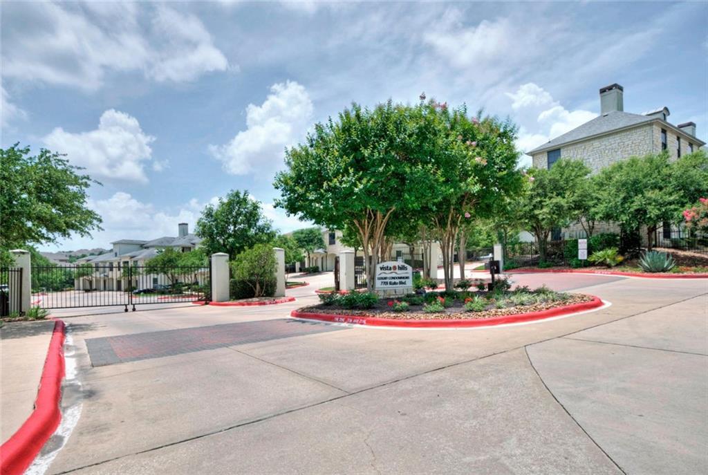 A welcoming gated community entrance with lush la